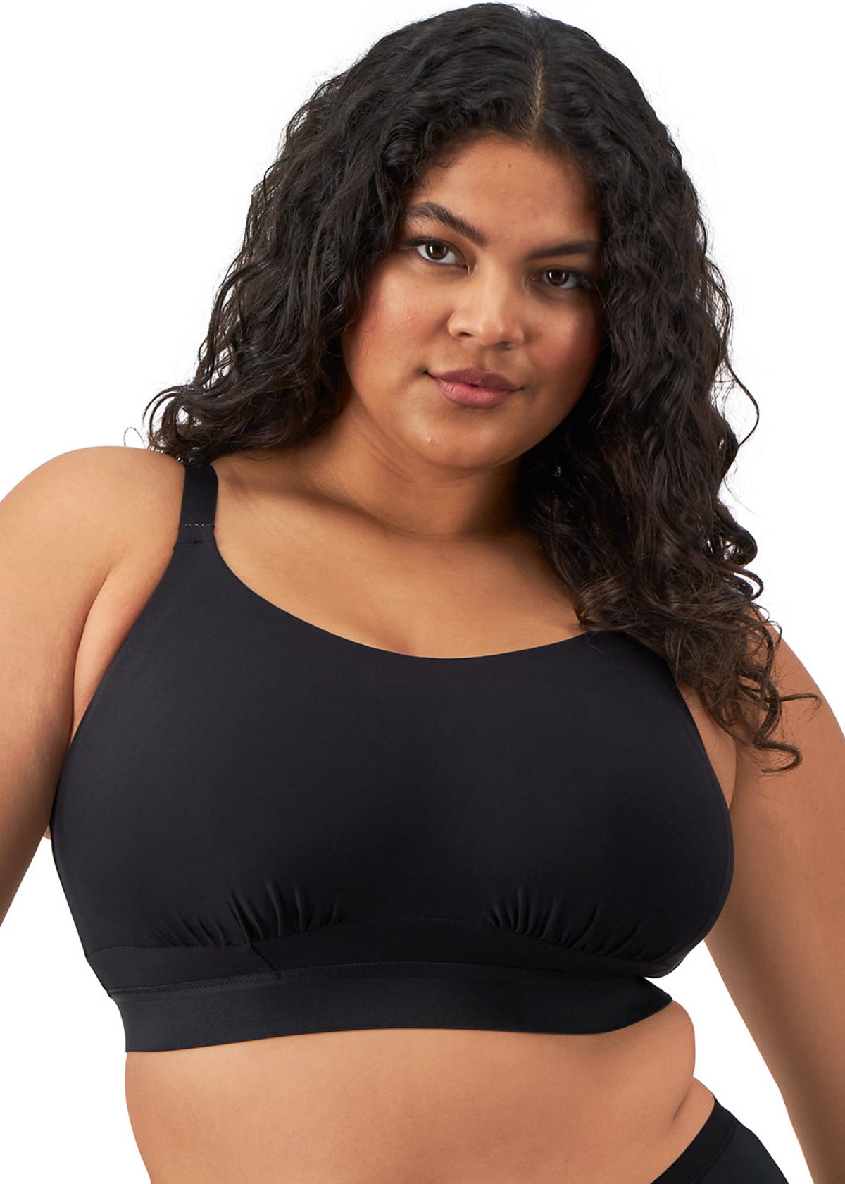 Woman wearing a black wireless bra on a white background
