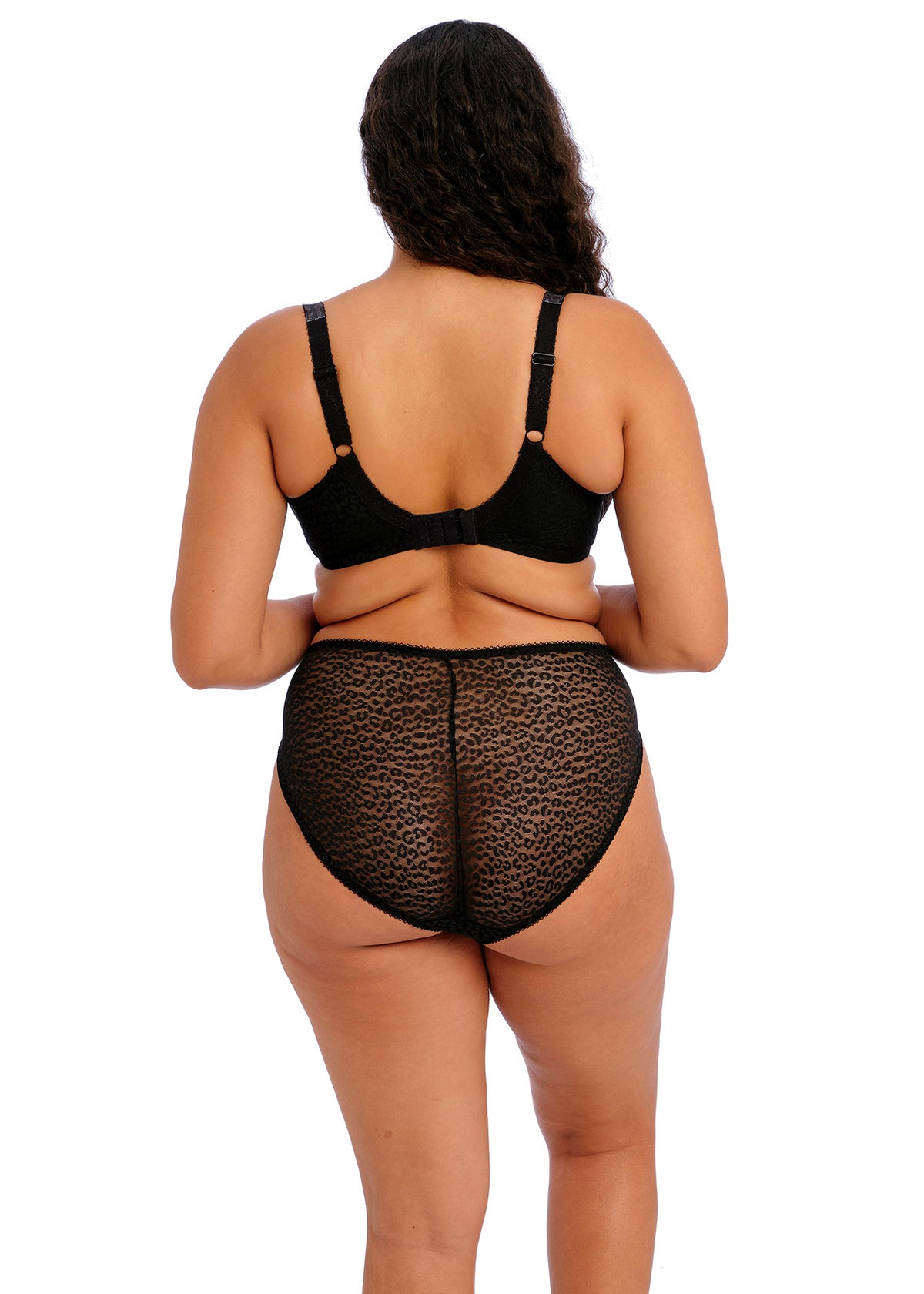 Person wearing a black bra and leopard print underwear on a white background