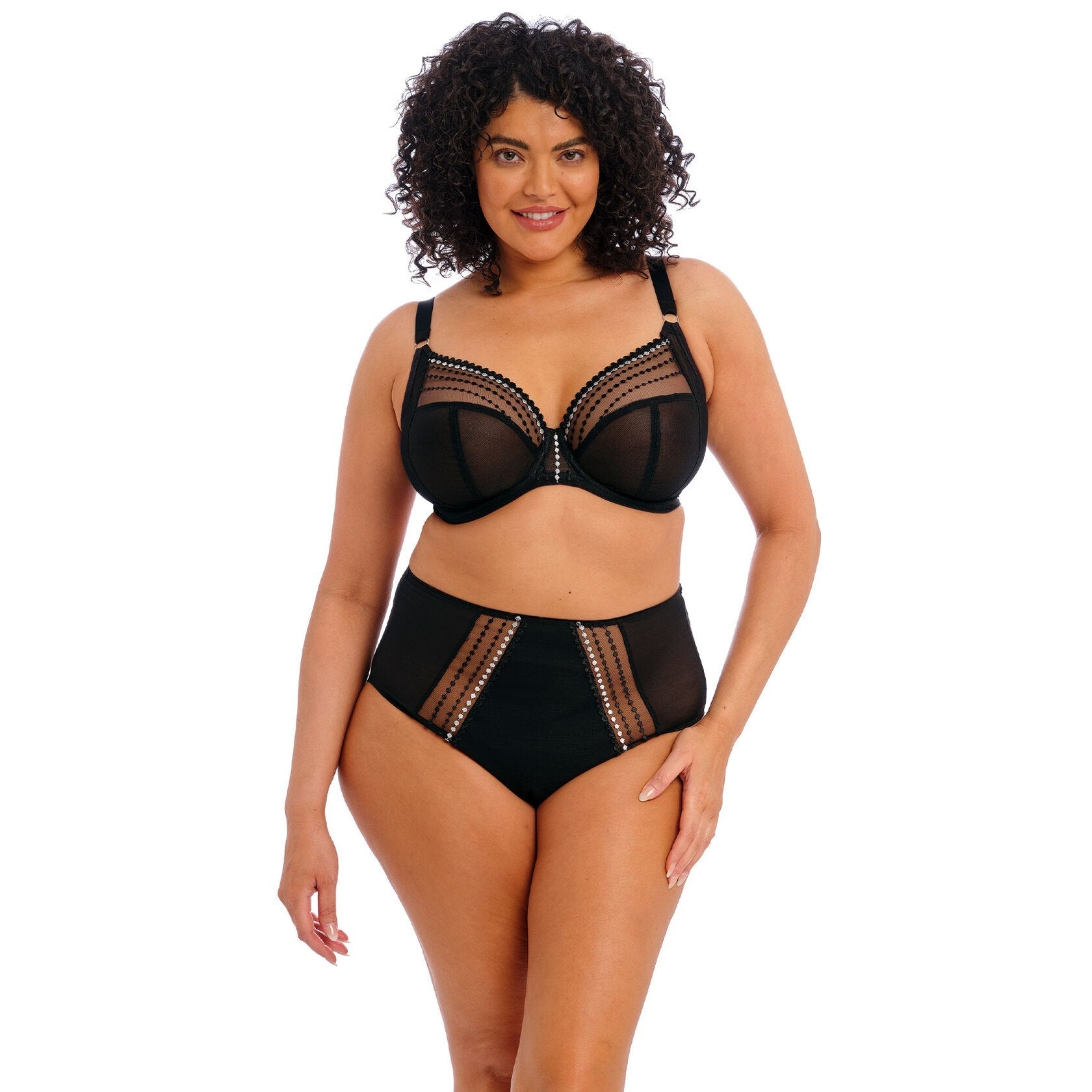 A woman wearing a black bra and underwear set on a white background.