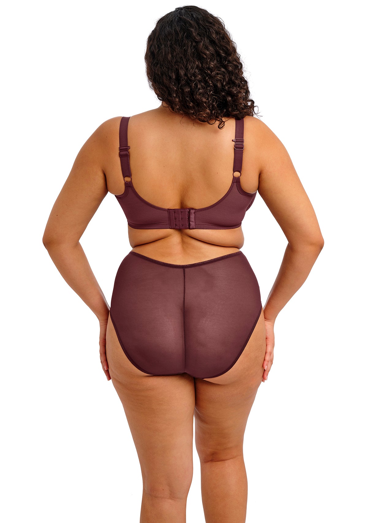 Woman wearing a brown shapewear garment on a white background