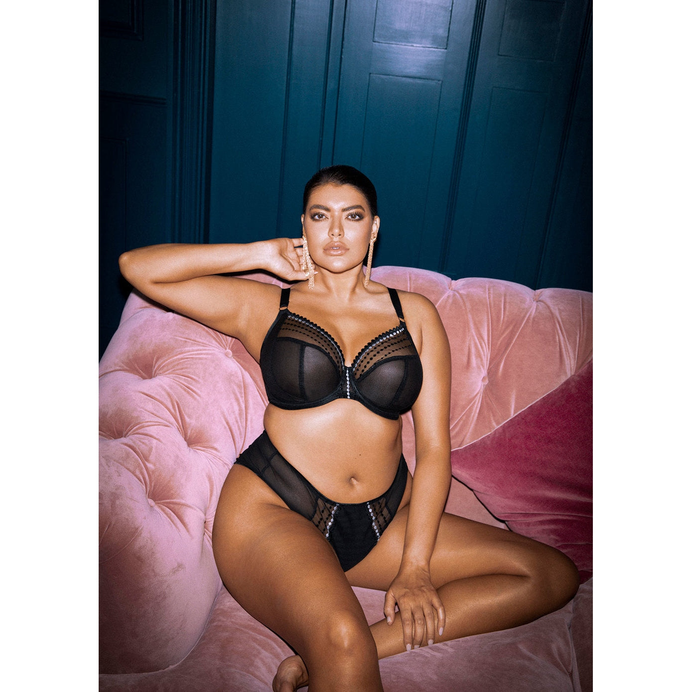 A model wearing a black Matilda Plunge Bra with three-piece cups and side support panels. The bra features a low center front and J-hook fastening.