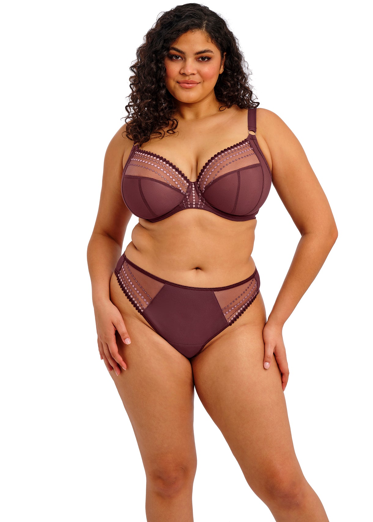 Woman wearing a maroon lingerie set on a white background