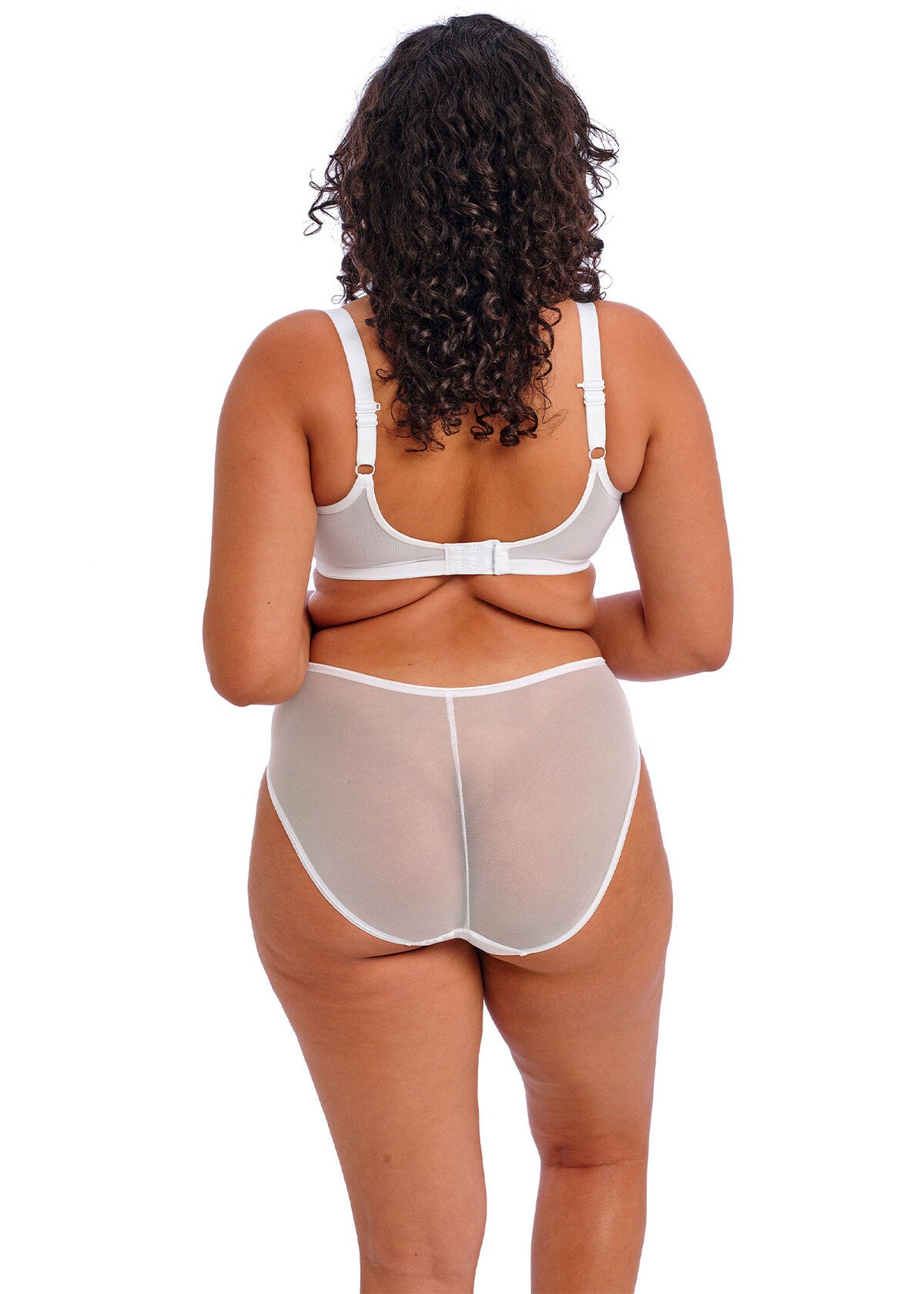 Person wearing a white bra and sheer white panties on a white background