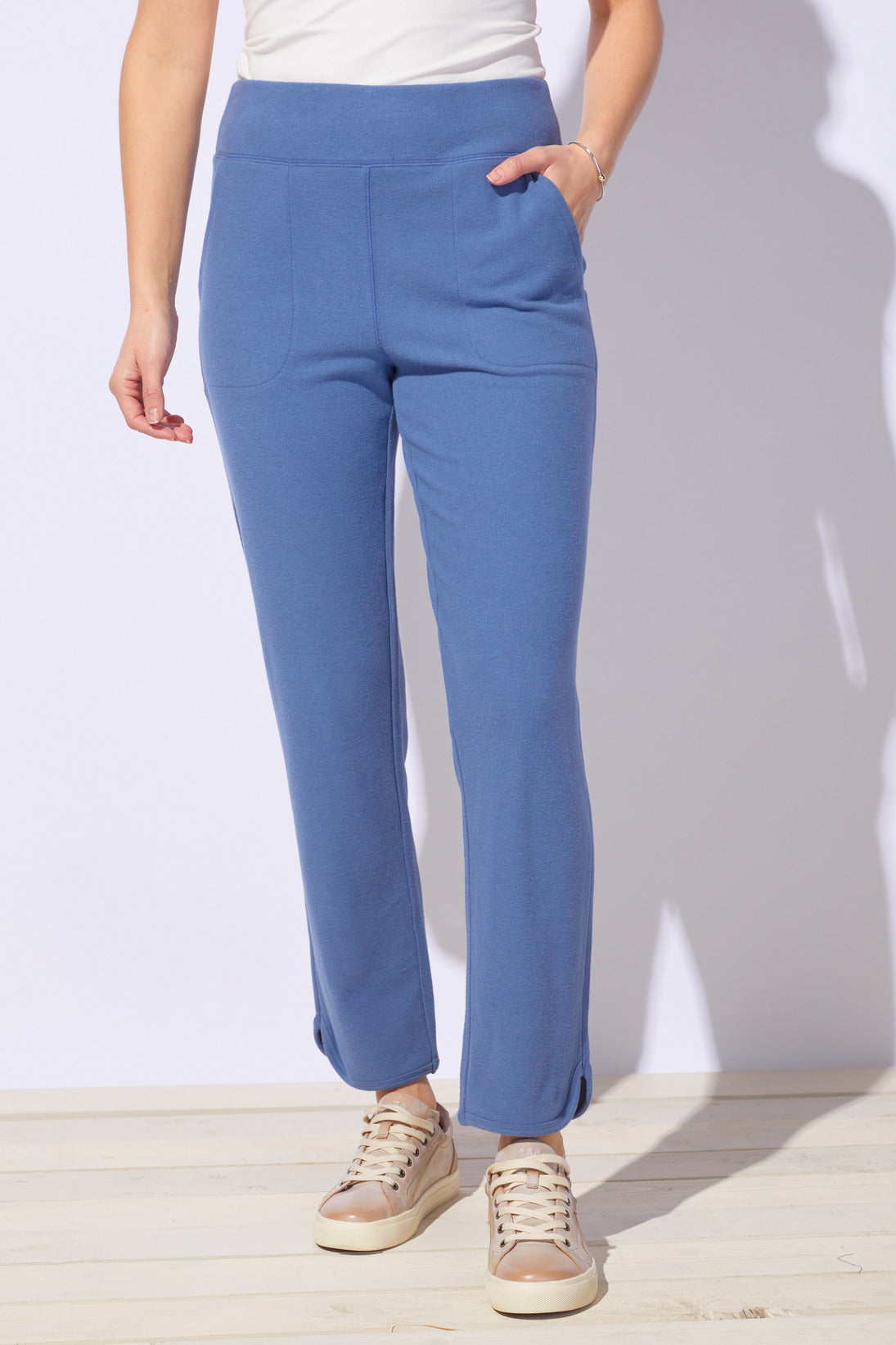 Blue pants worn by a person on a white background