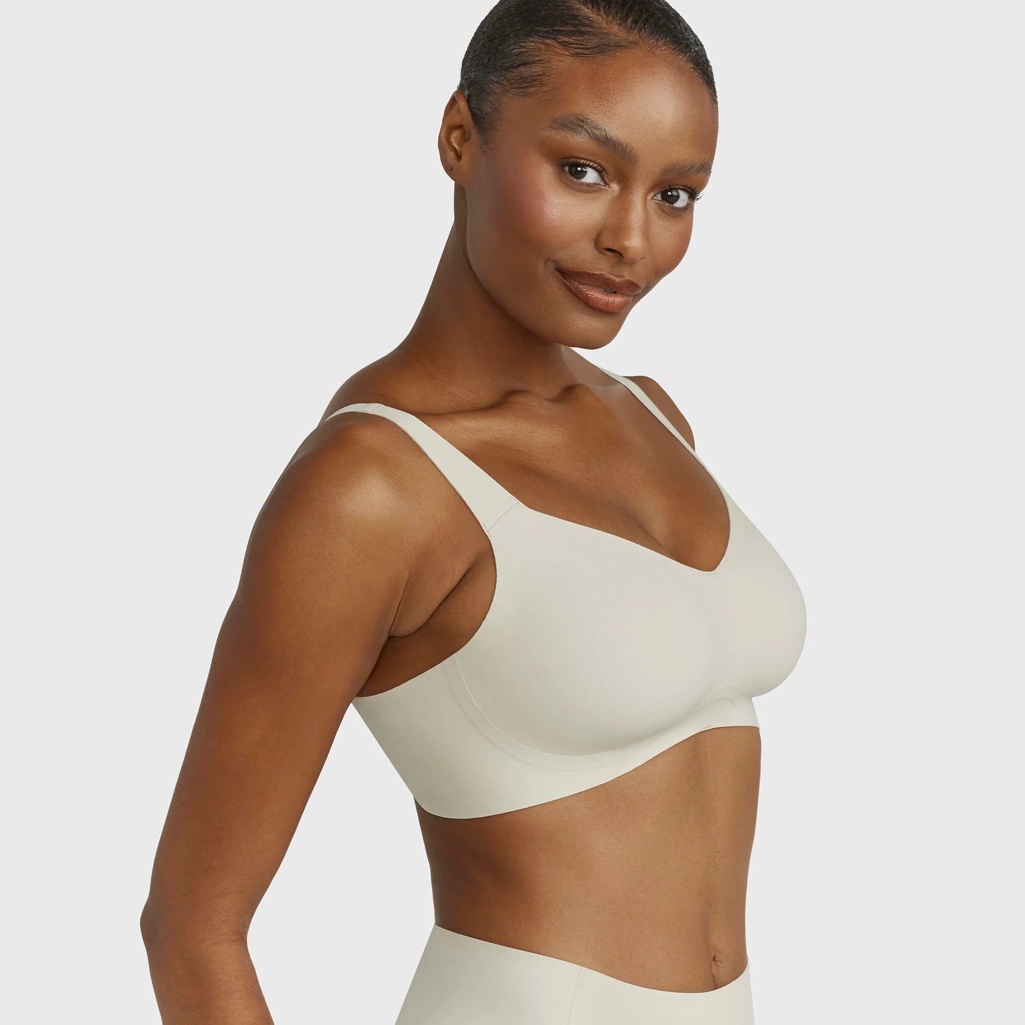 Beyond Bra in Aloe, light sage green wirefree bra on a model shown from a side view of the side band.