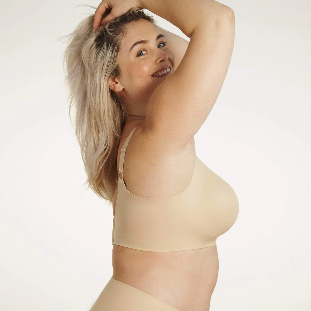 Beyond Bra in Sand, beige wirefree bra shown on a model with her arms up showing the side of the band.