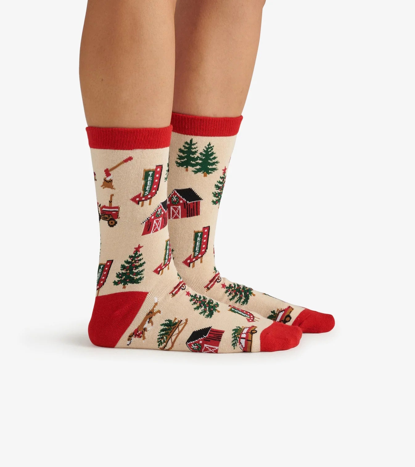 Christmas-themed socks with reindeer, trees, and presents on a white background
