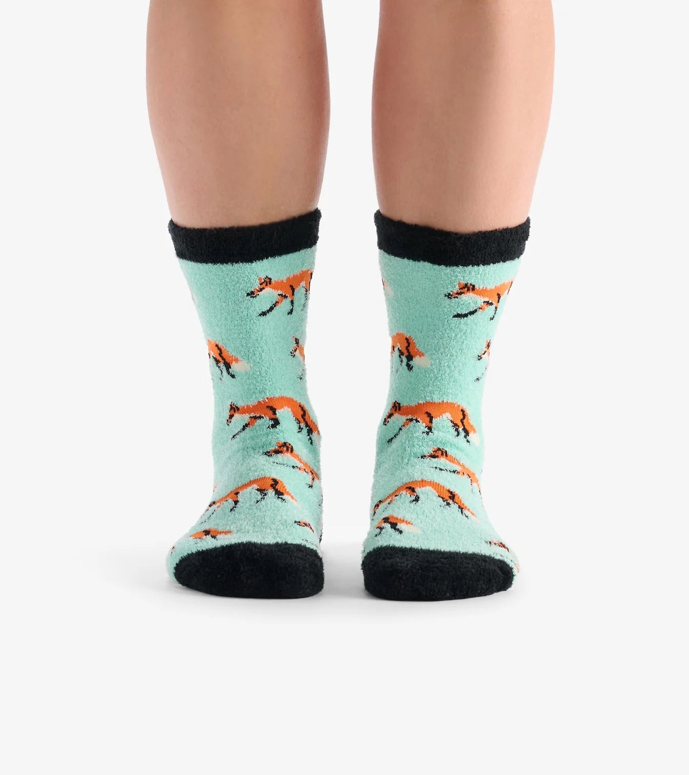 Teal socks with fox pattern worn by a person on a white background