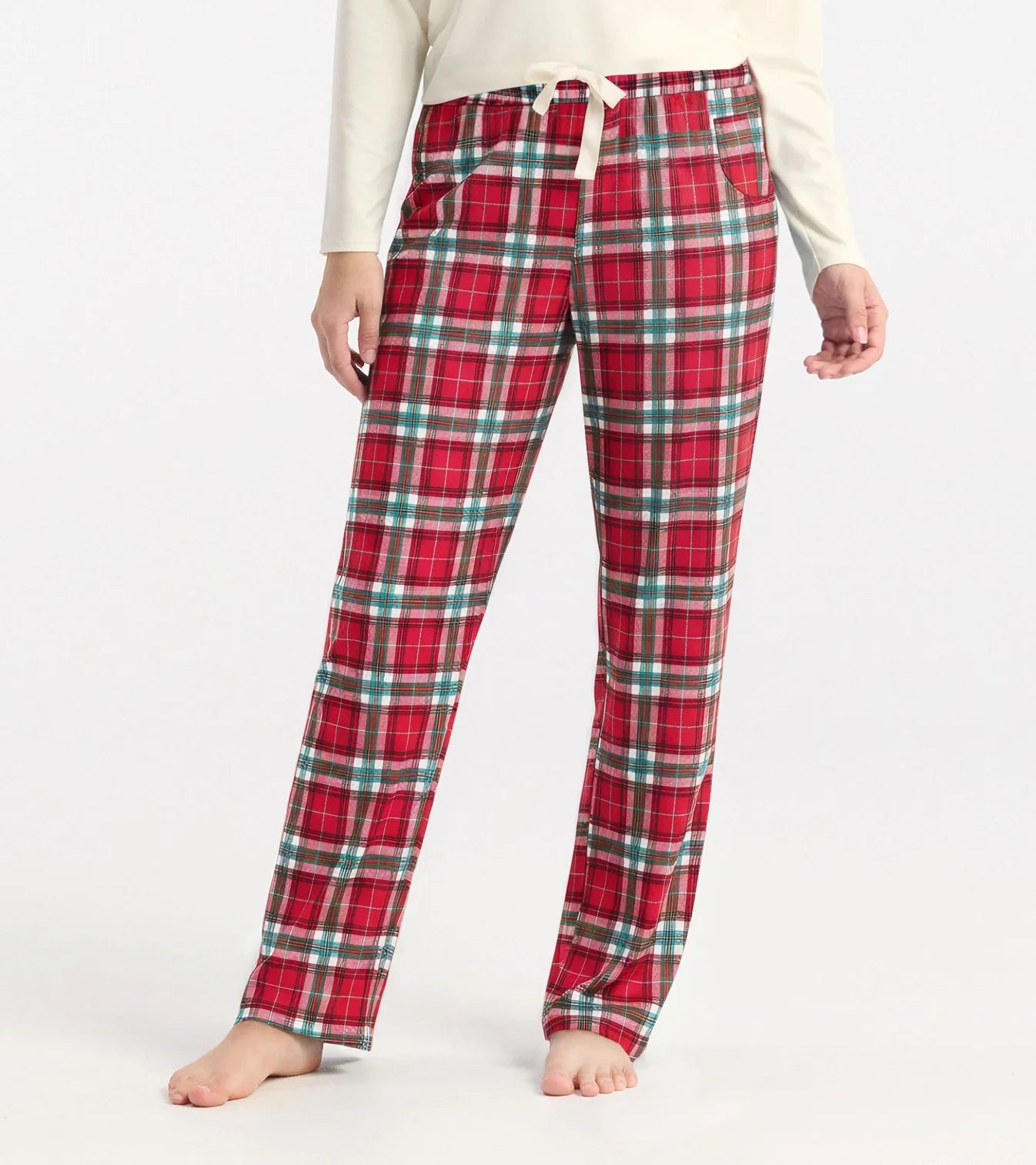 Red plaid pajama pants worn by a person on a white background