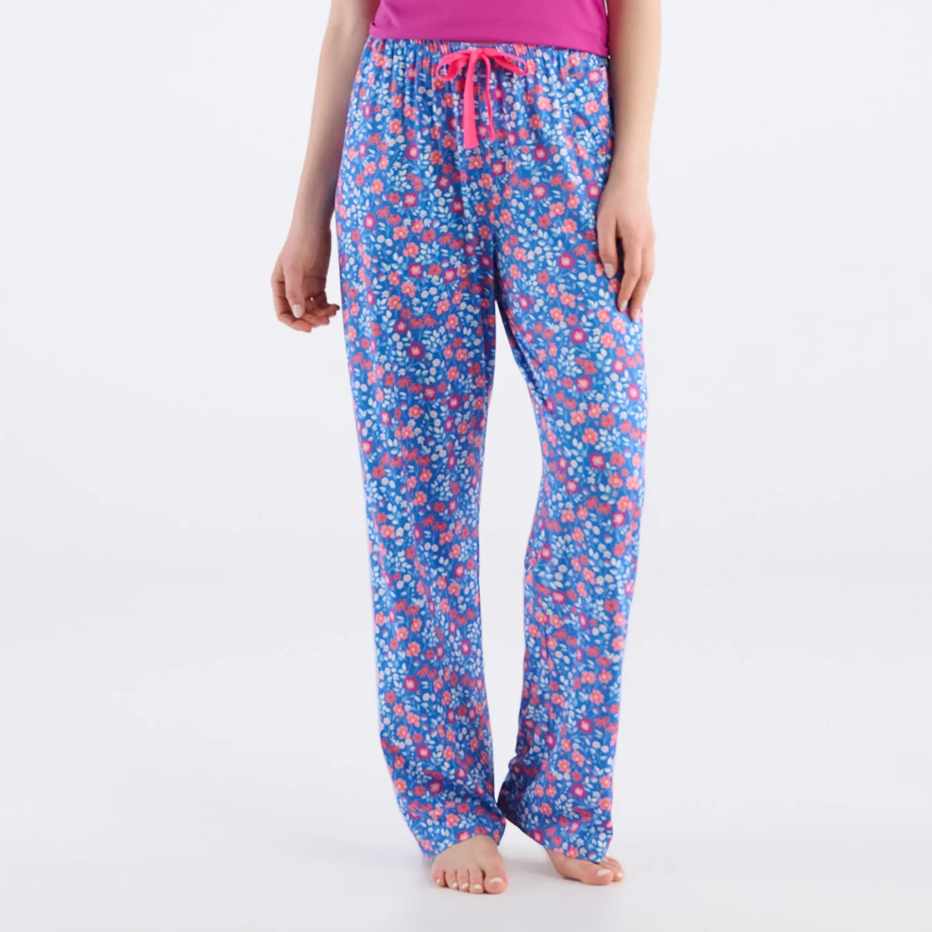 Floral patterned pajama pants worn by a person on a white background