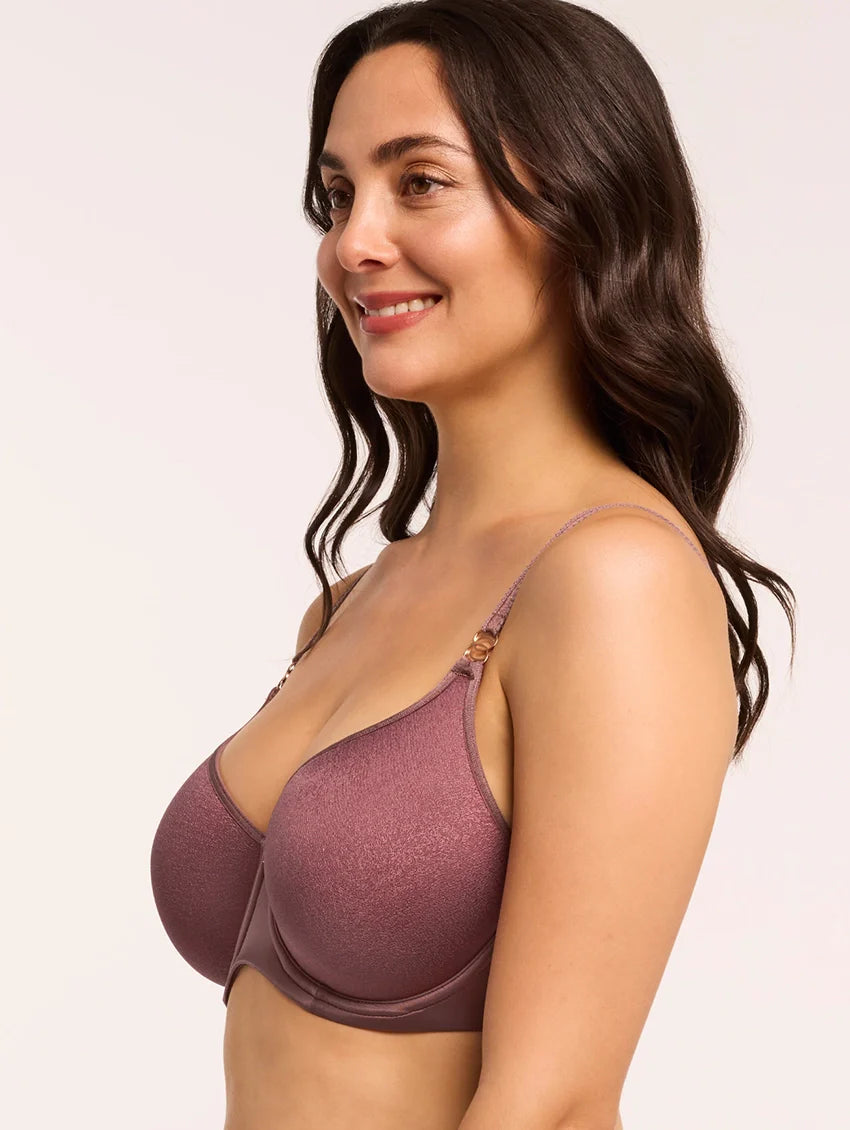 Woman wearing a purple bra against a plain background