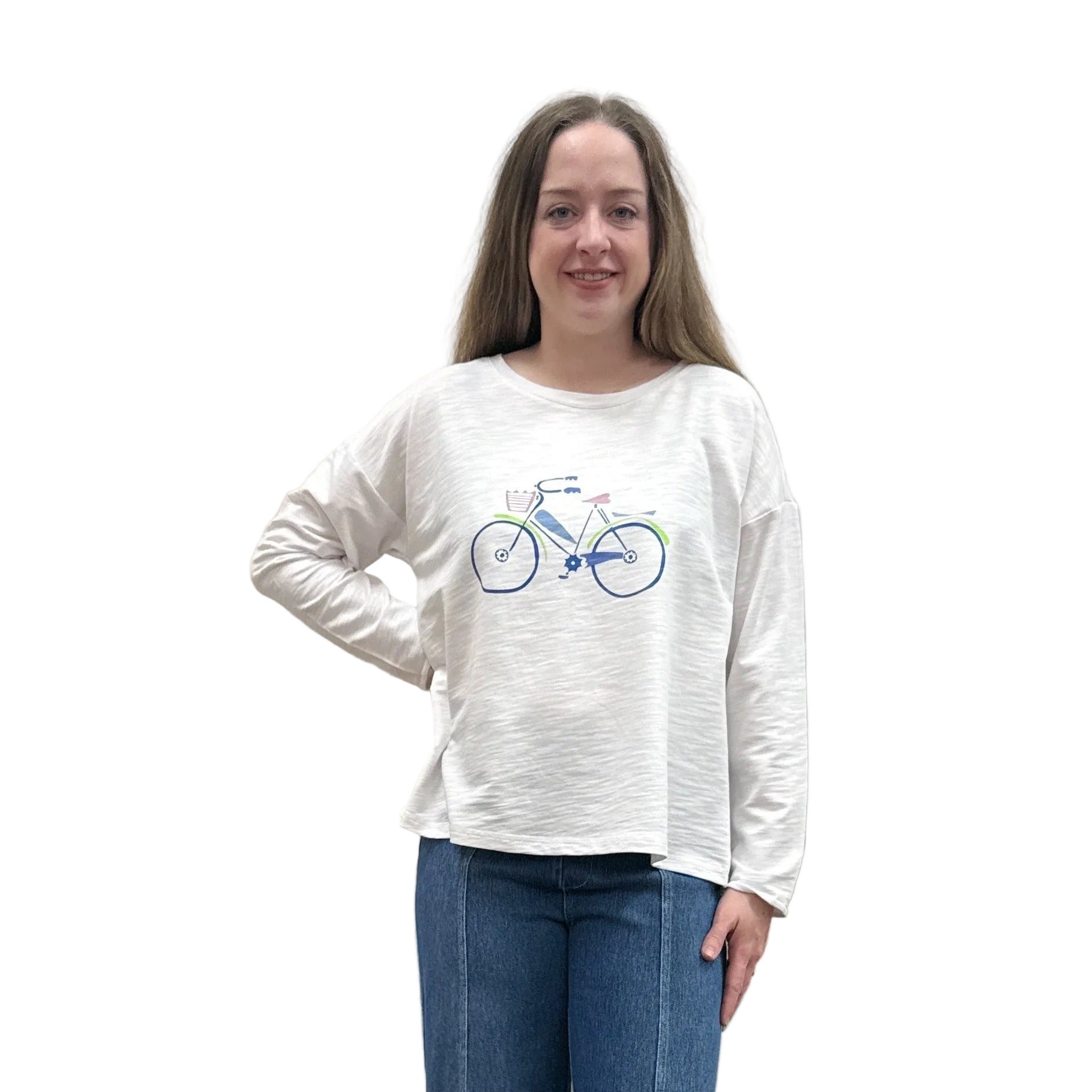 Person wearing a white long-sleeve Papa Bicycle Pullover shirt and blue jeans standing on a white background.