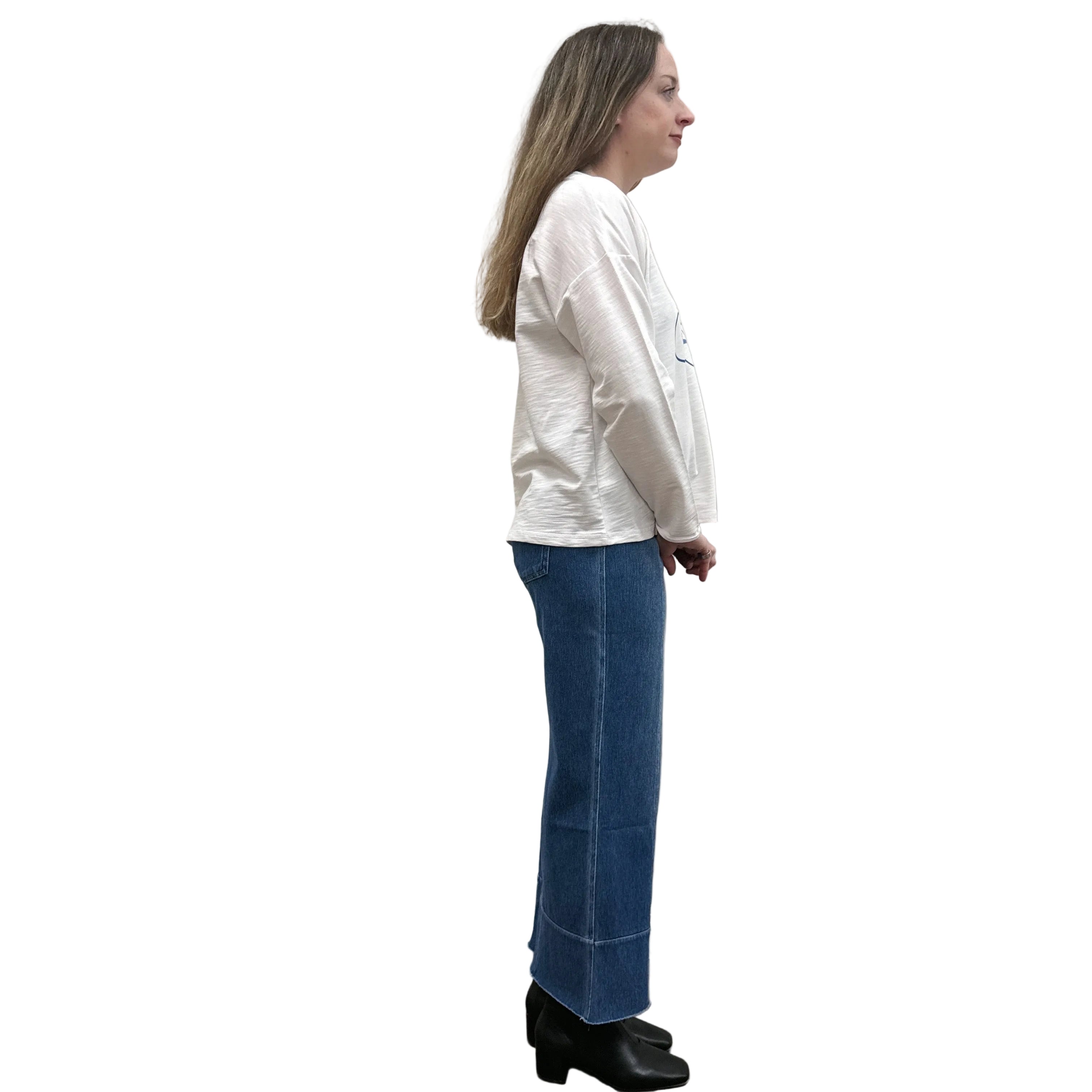 Person wearing a white long-sleeve Papa Bicycle Pullover shirt and blue jeans standing on a white background.