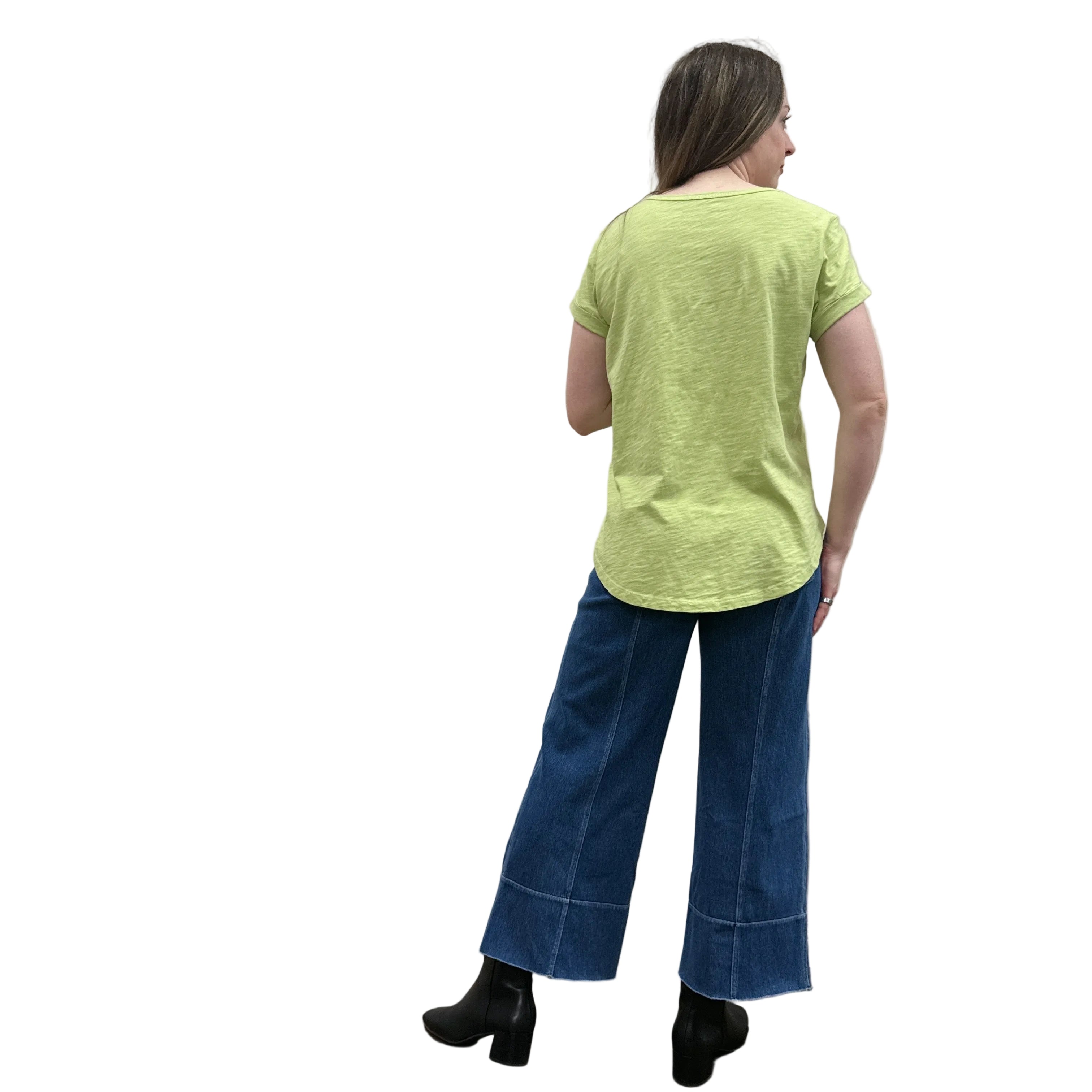 Person wearing a green Papa Cuffed Sleeve shirt and blue pants on white background.