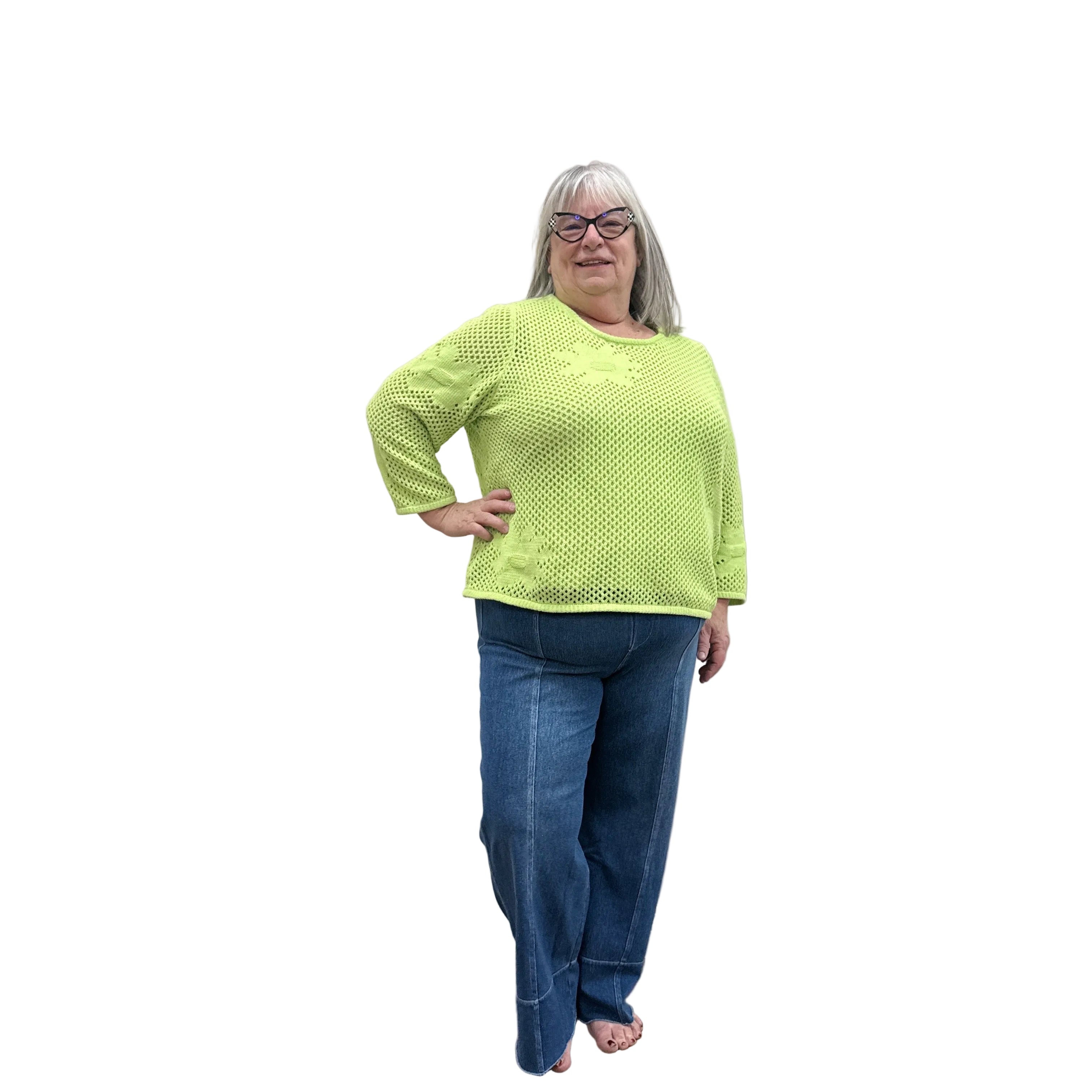 Person wearing a bright green Papa Easy Pullover sweater and blue jeans standing against a plain wall.
