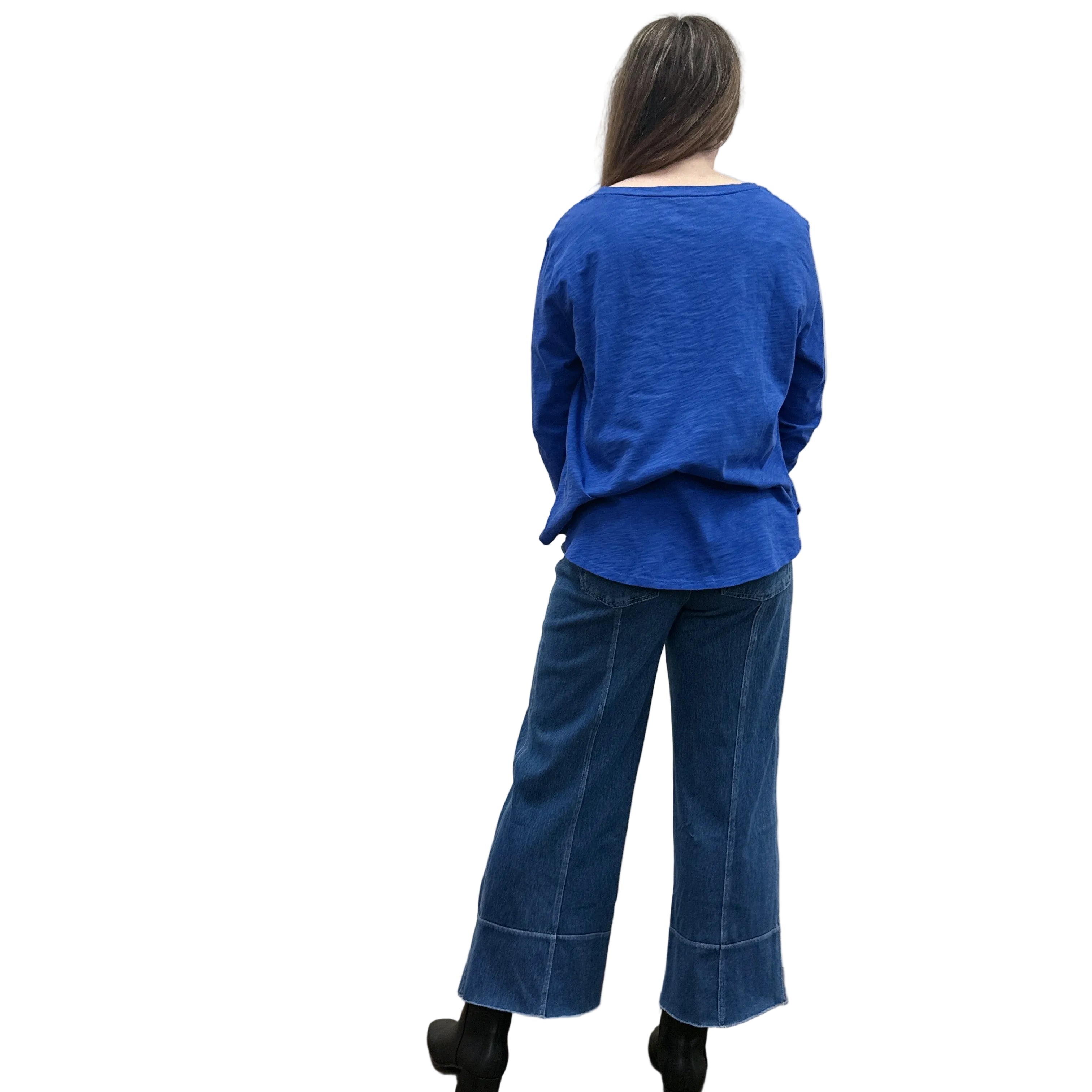 Person wearing a blue Papa High Low longsleeve top and jeans on a white background.