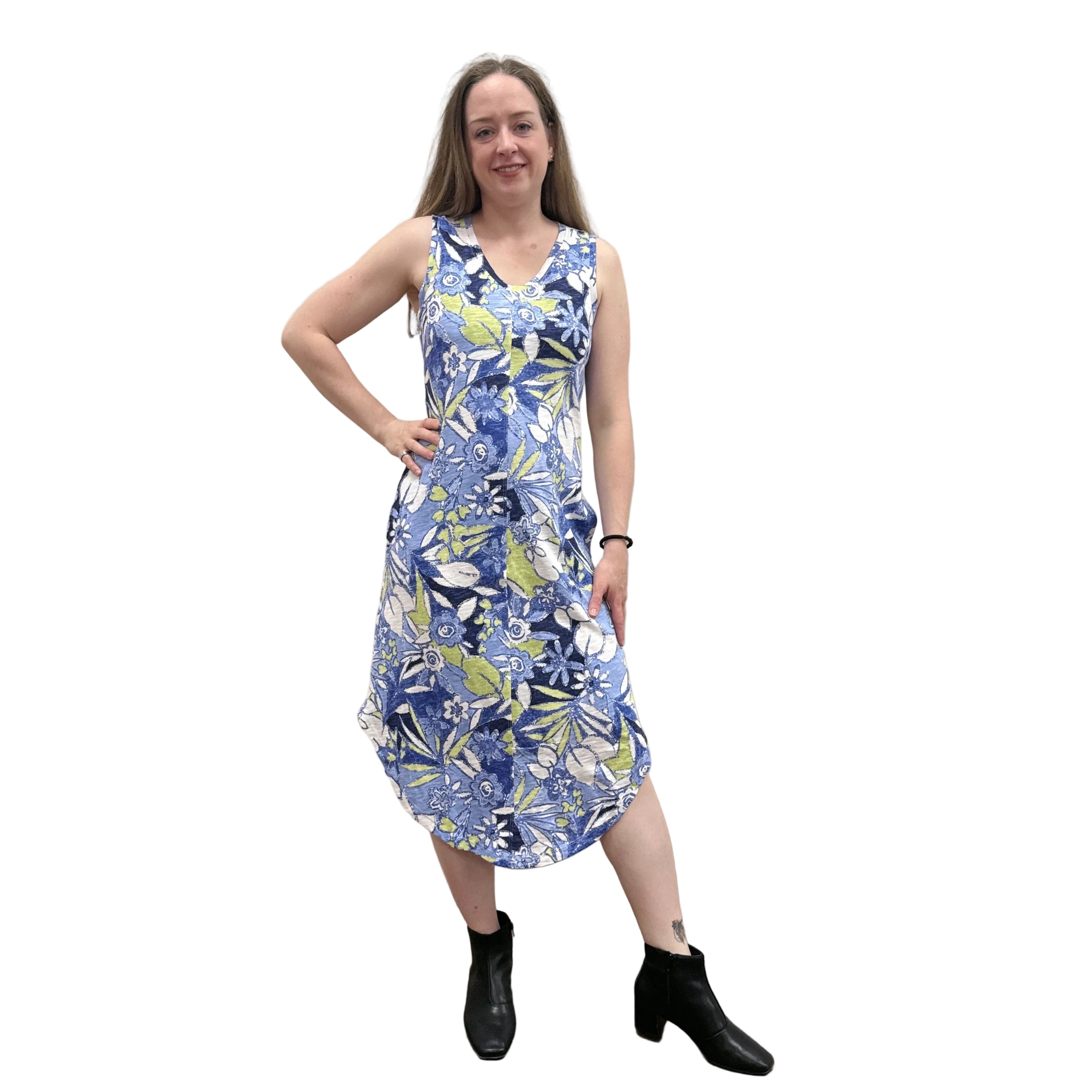 Woman wearing a blue floral Papa Seamed Sleeveless dress standing against a plain wall.