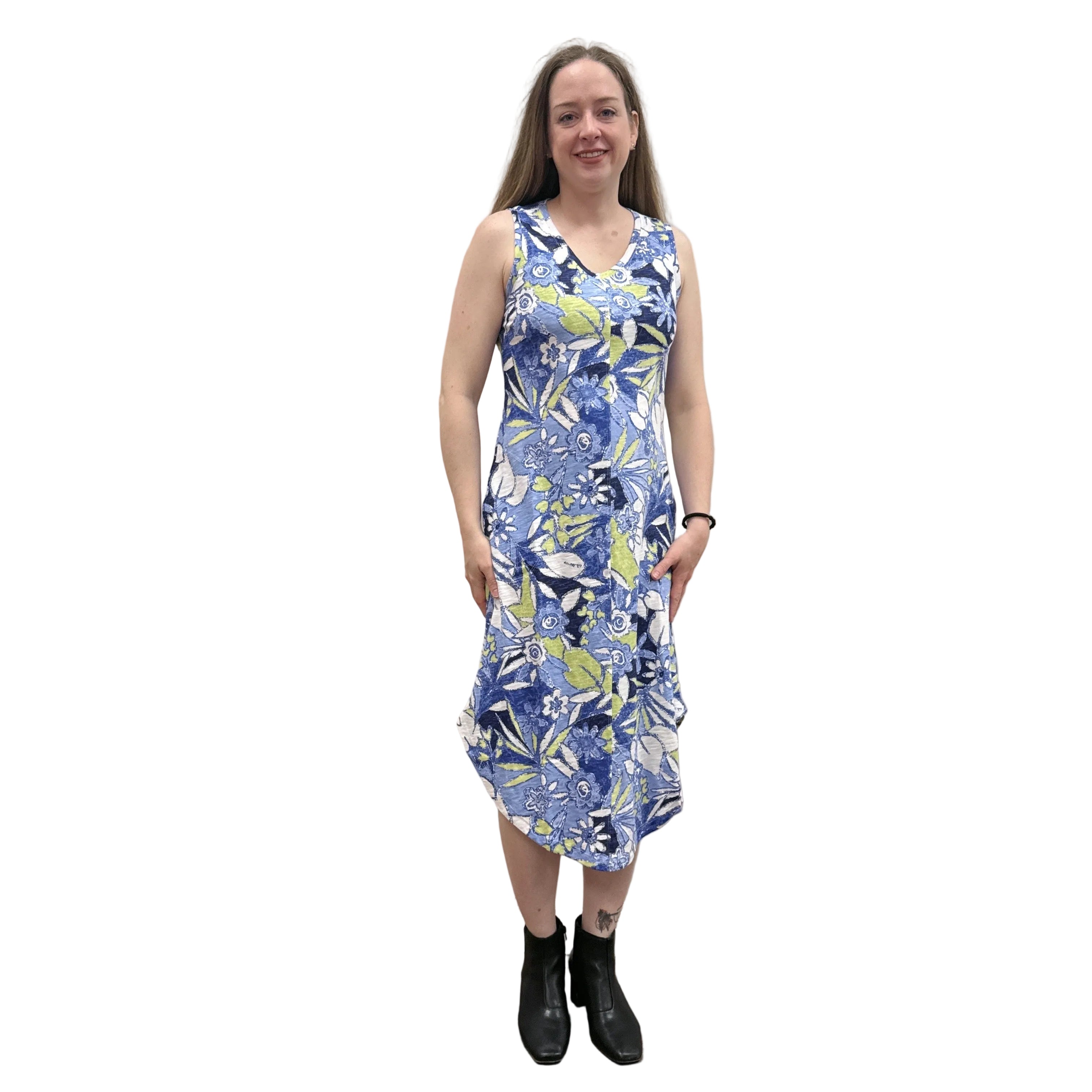 Woman wearing a blue floral Papa Seamed Sleeveless dress standing against a plain wall.