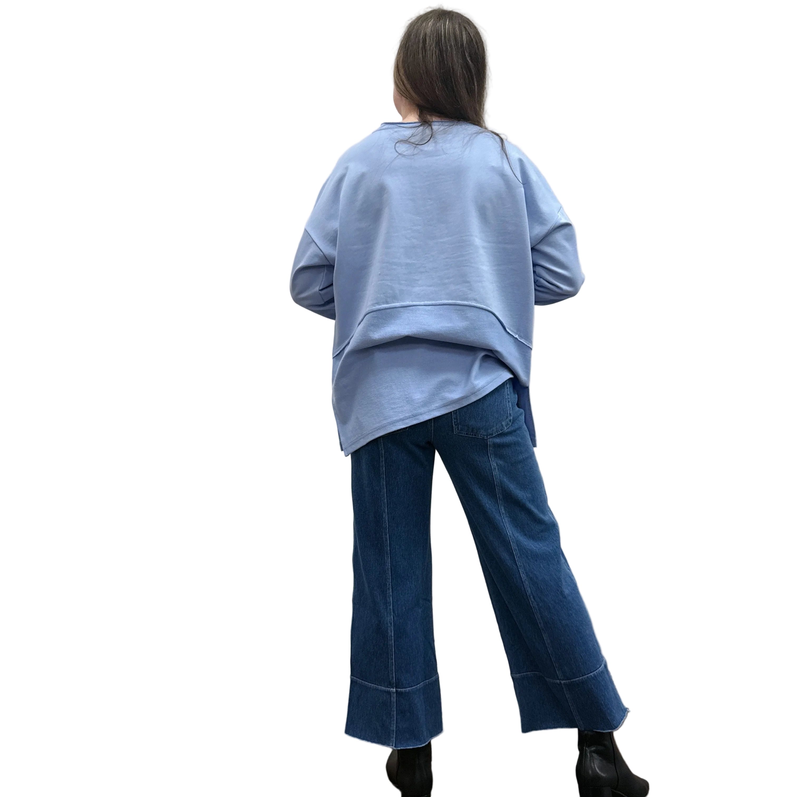 Person wearing a blue Papa Weekend Pullover sweater and jeans standing against a plain wall.