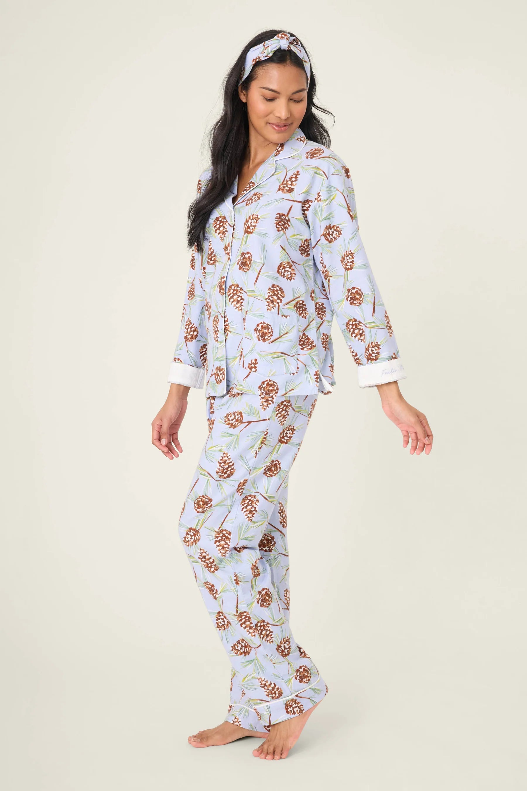 Woman wearing a pine pajama set on a white background