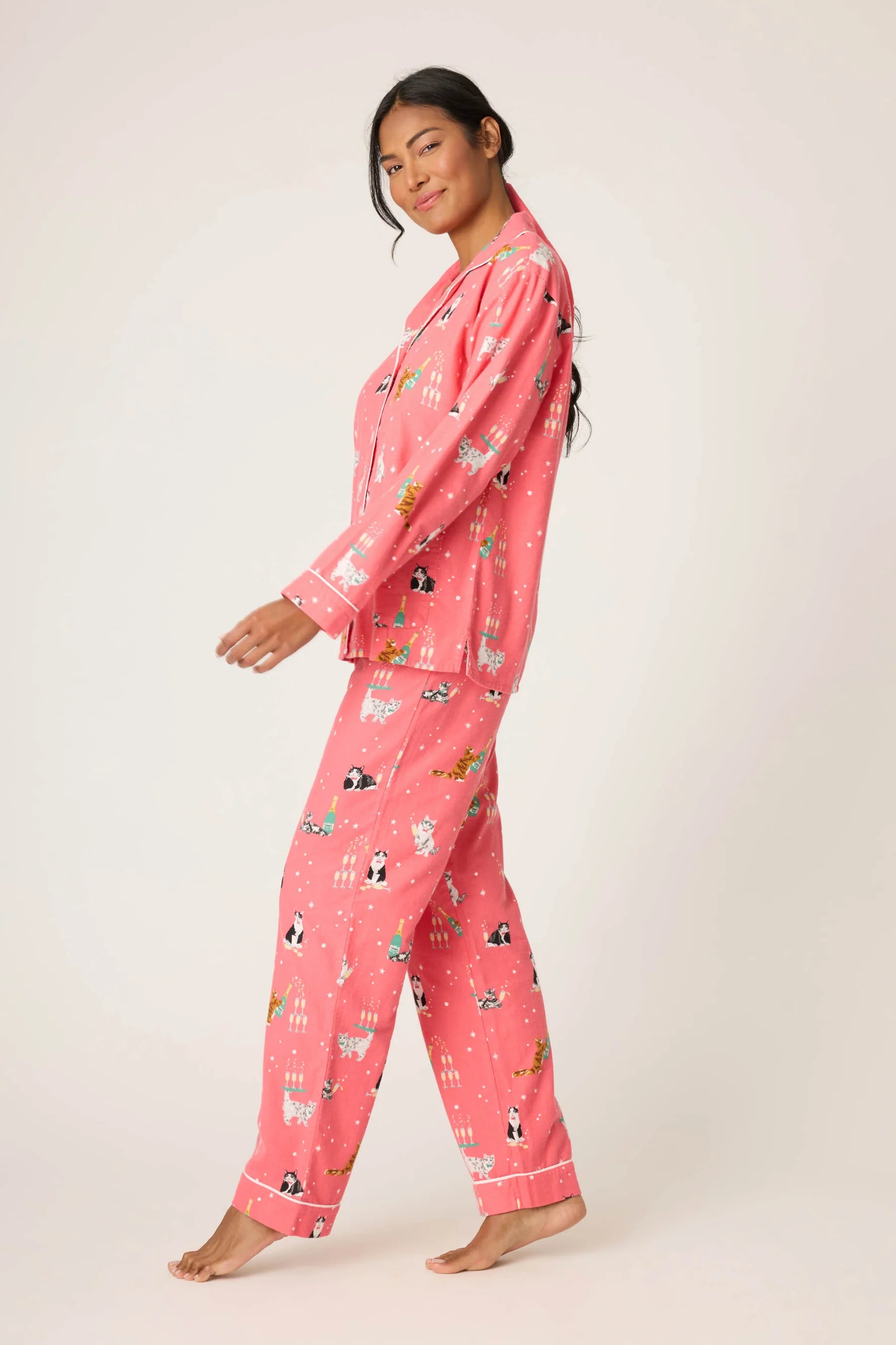 Woman wearing pink pajamas with a pattern on a white background