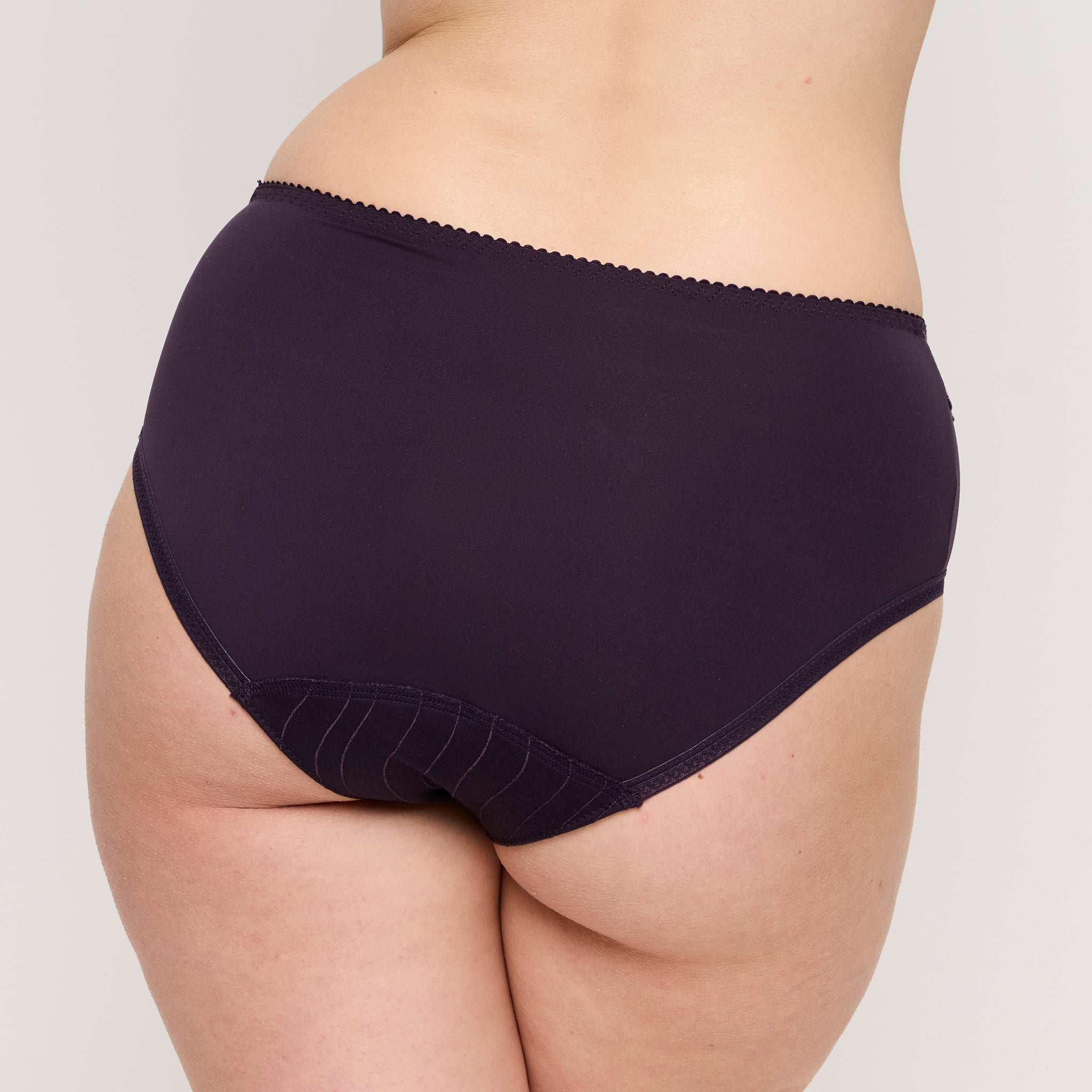 Navy blue high-waisted underwear on a neutral background