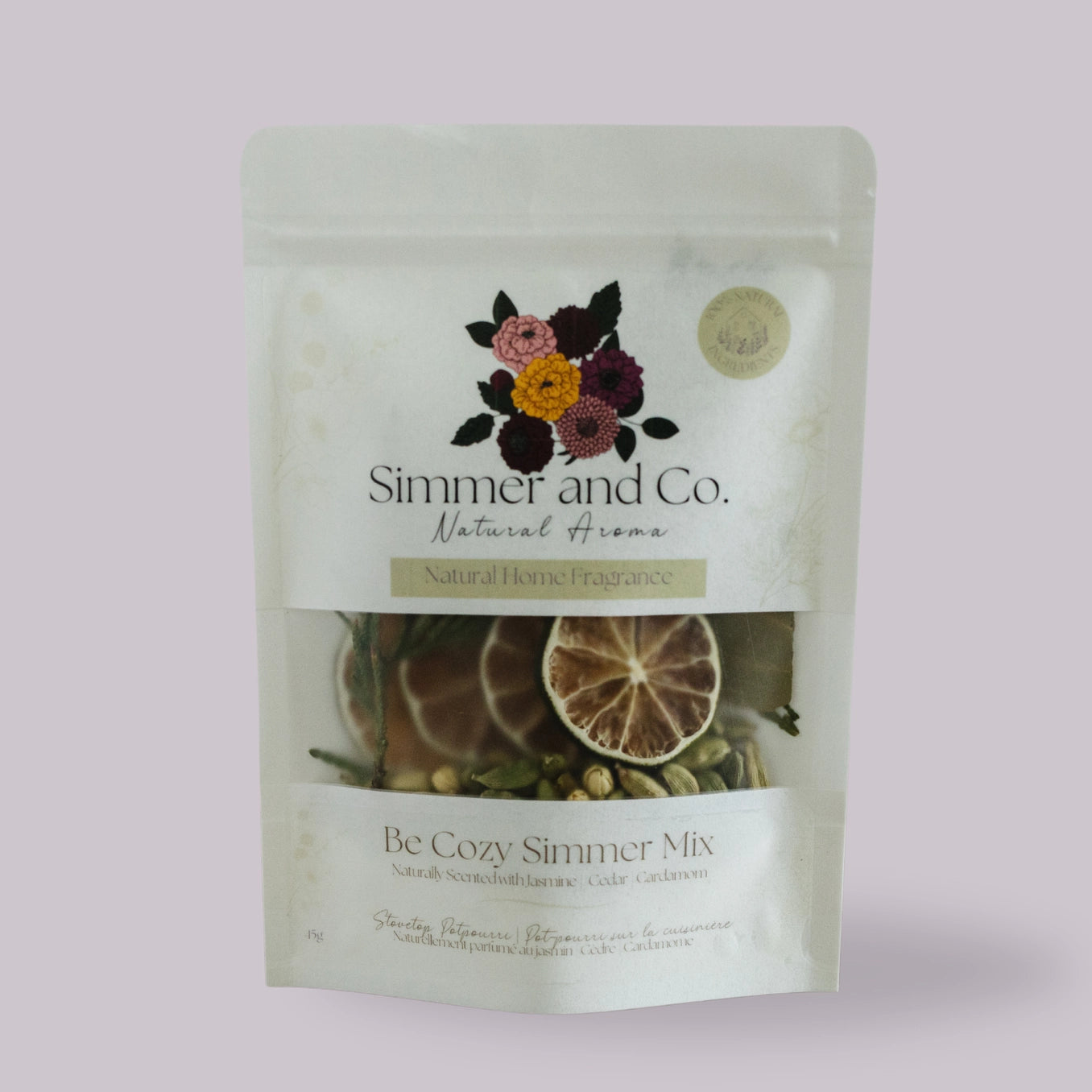 Package of 'Simmer and Co.' natural home fragrance with floral design on a light pink background