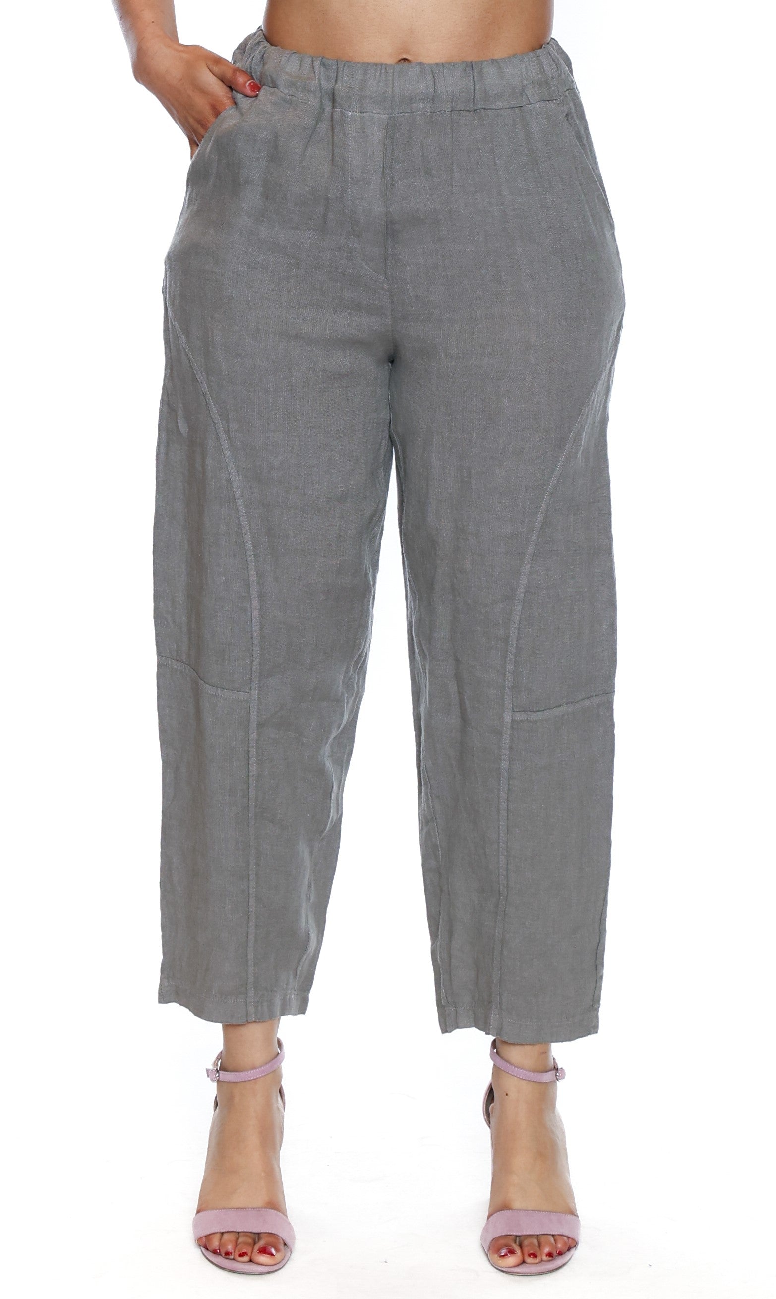 Sage green pants worn by a person on a white background