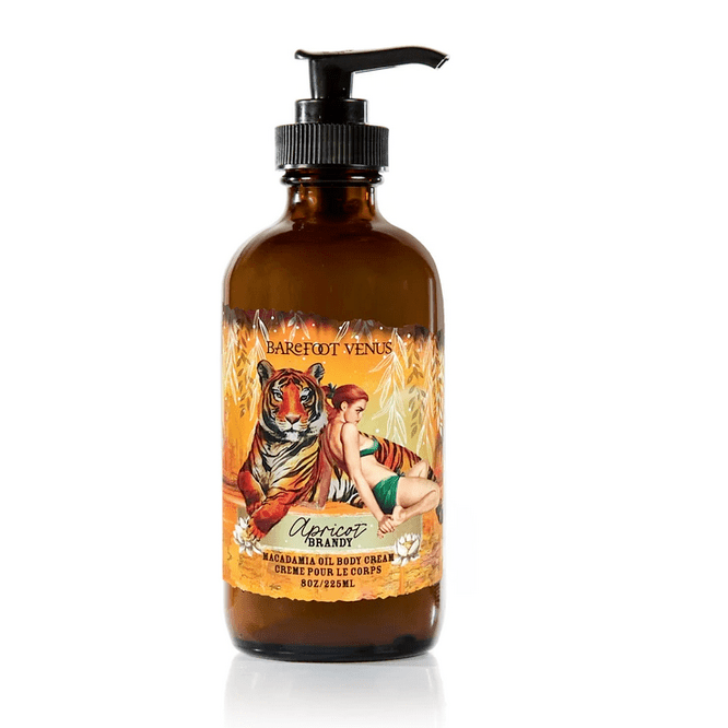 Barefoot Venus Macadamia Oil Body Lotion in Apricot Brandy in a Brown bottle with a pump and yellow label on a white background