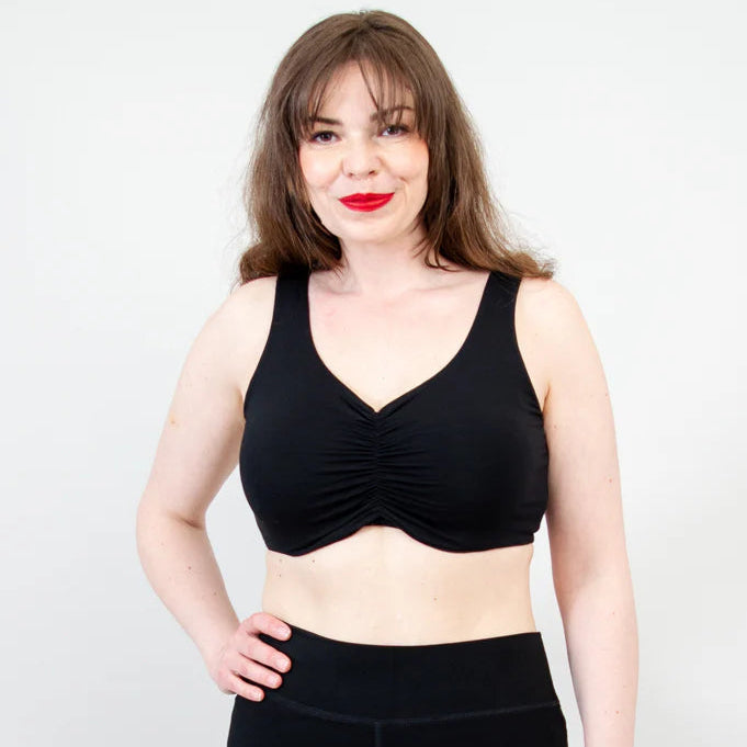 Blue Sky Clipper Top in Black shown on a model against a white background, worn with black bottoms.