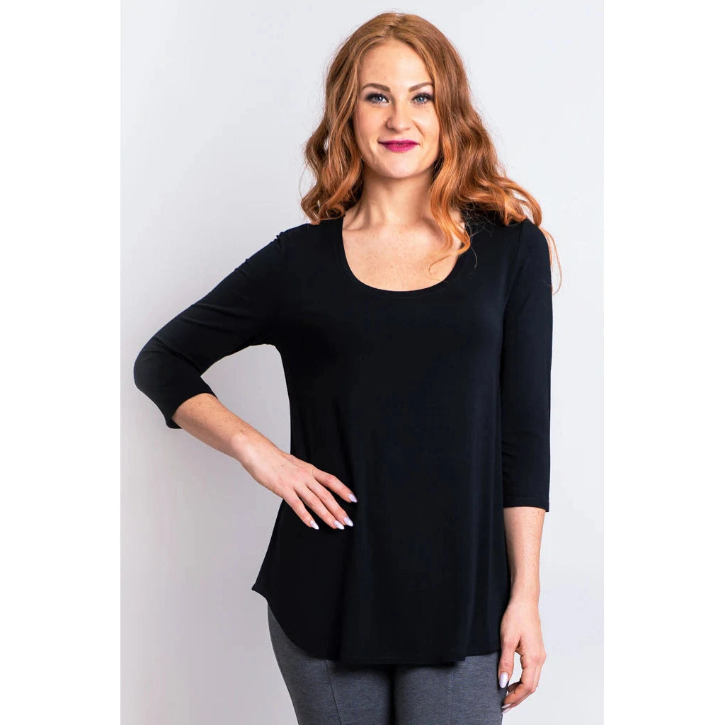 Blue Sky Jazz 3/4 Sleeve Top in Black shown on a model wearing grey leggings standing against a white background, from the front view.