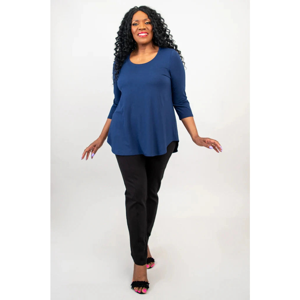 Blue Sky Jazz 3/4 Sleeve Top in Indigo shown on a model wearing black leggings standing against a white background, from the front view.