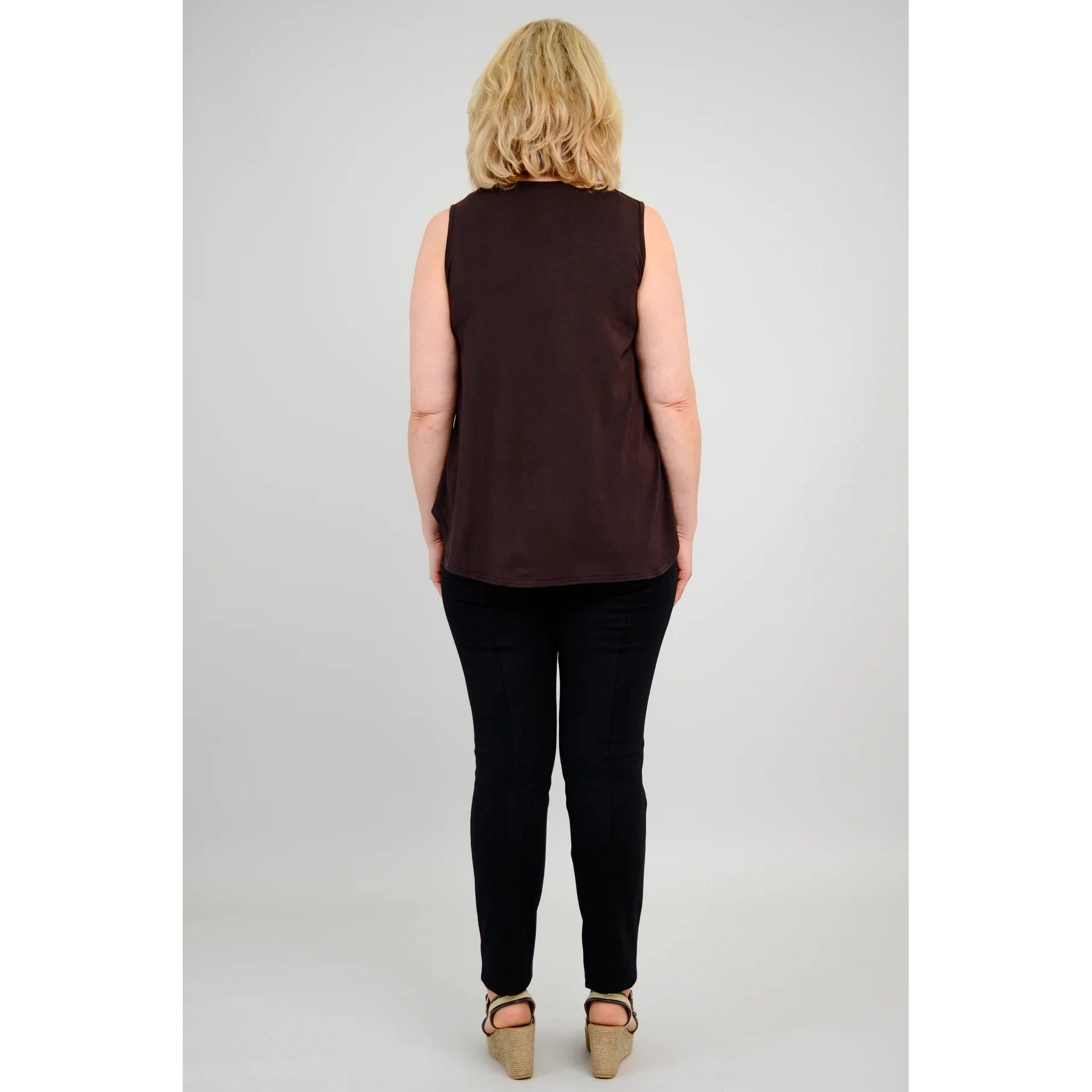 Blue Sky Jazz Tank in Coffee shown on a model wearing black leggings, against a white background, from the back view.