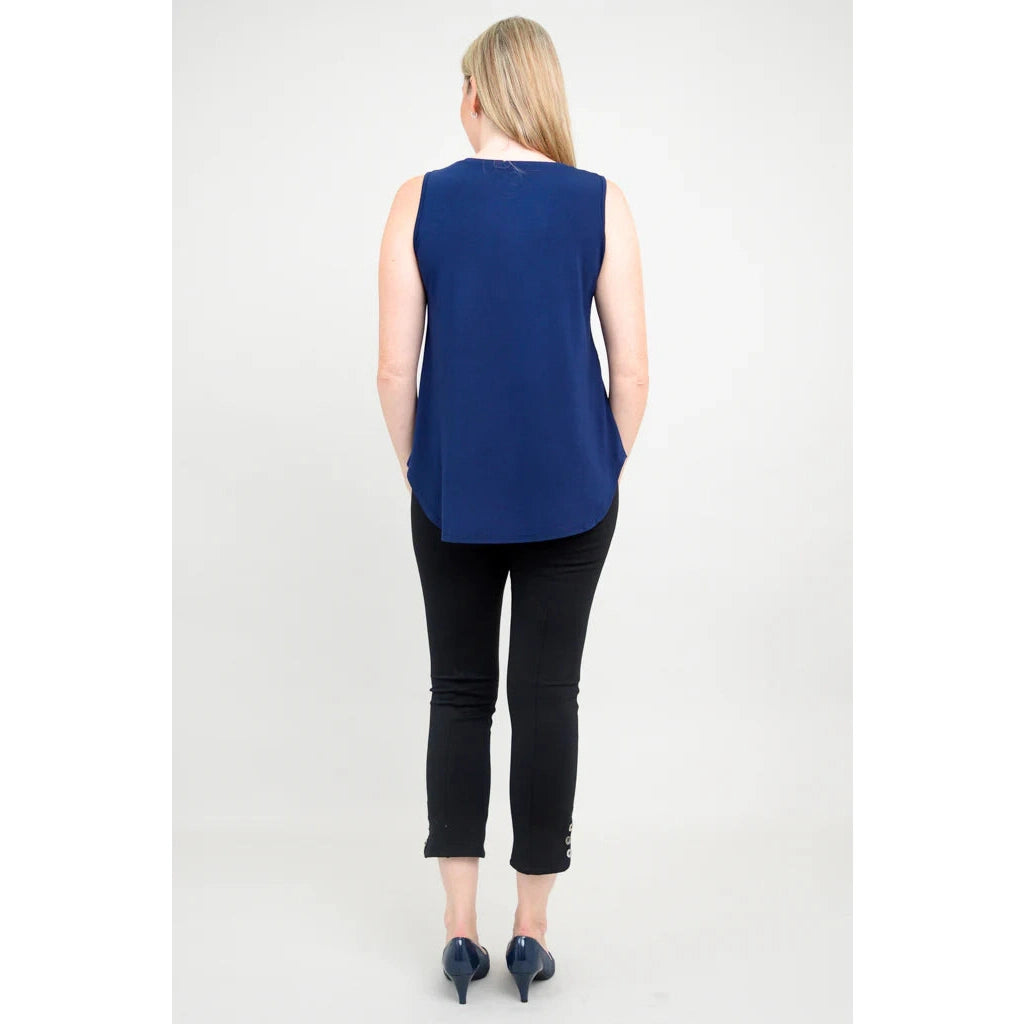 Blue Sky Jazz Tank in Indigo shown on a model wearing black leggings standing against a white background, from the back view.