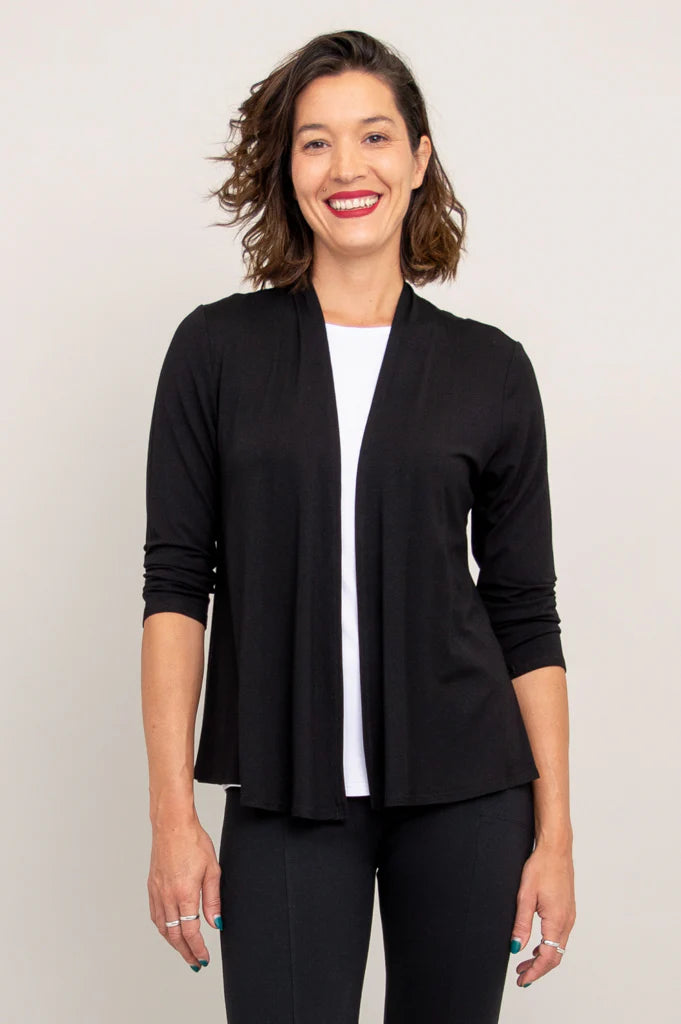 Blue Sky Kathy Jacket in Black shown on a model wearing it over a white tank with black pants against a white background, shown from the front.