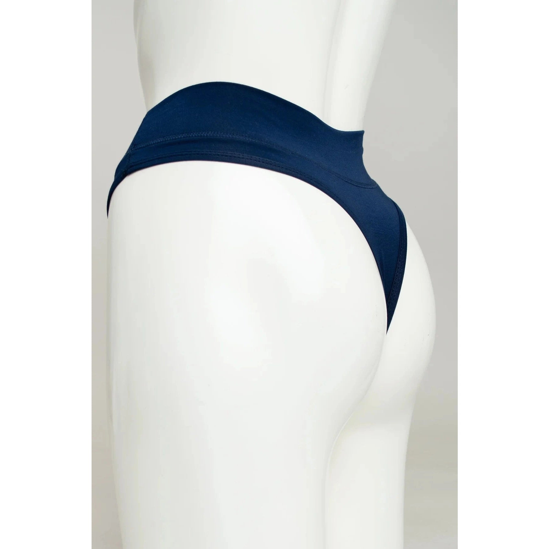Blue Sky La Thong in Indigo, dark navy, shown on a mannequin against a white background, from the side view.
