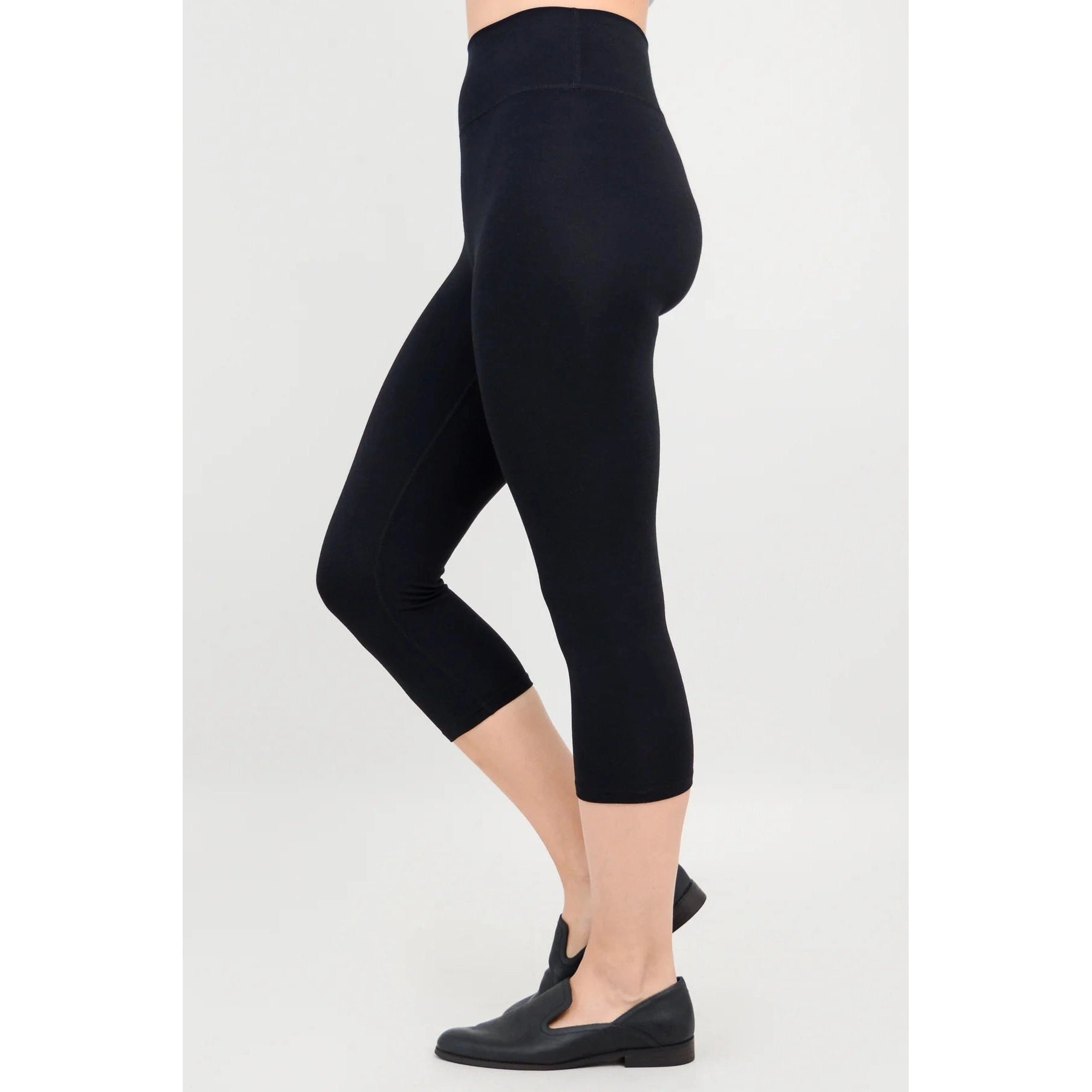 Blue Sky Riley Capris in Black shown on a model against a white background, from the side view.