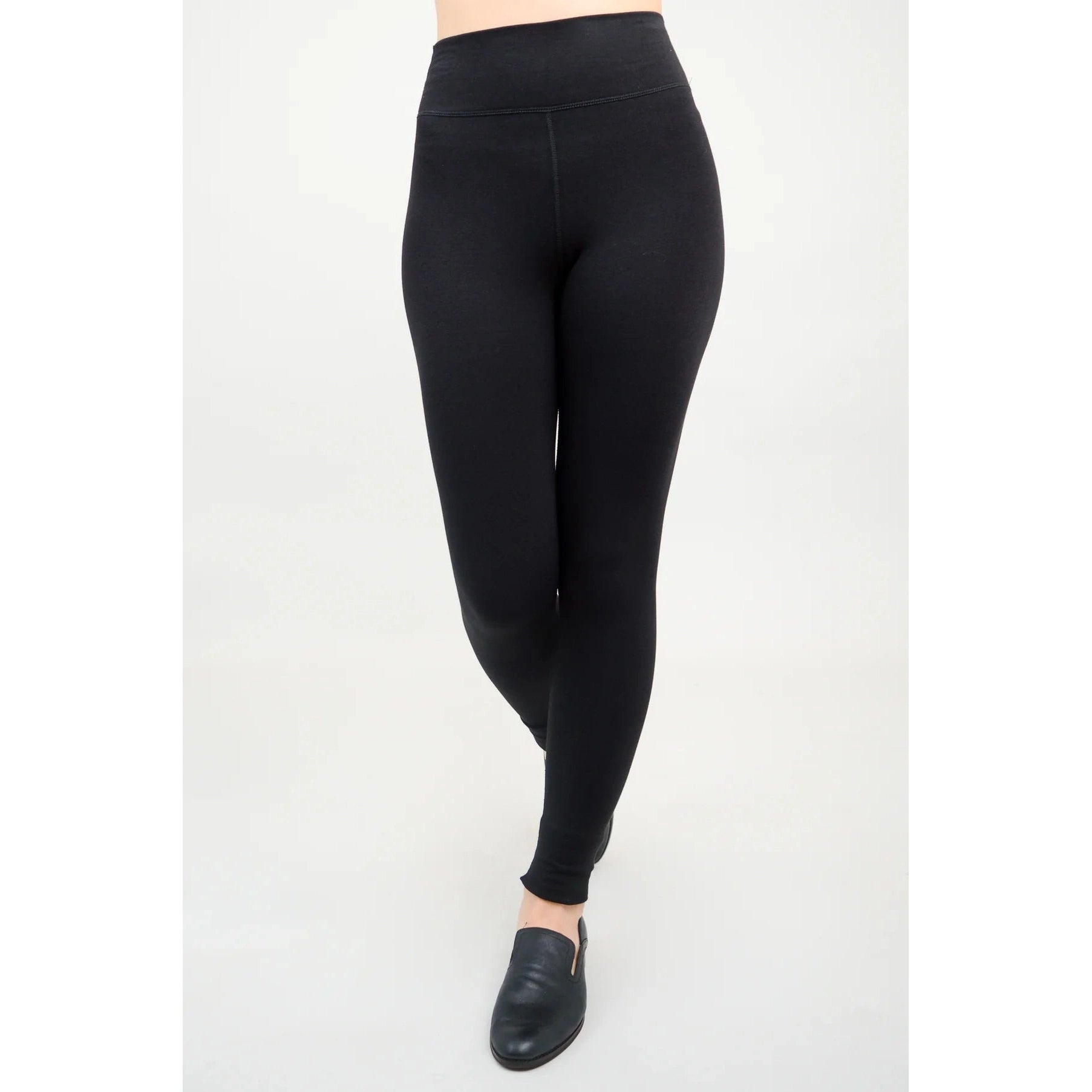 Blue Sky Riley Leggings in Black shown on a model against a white background, from the front view.