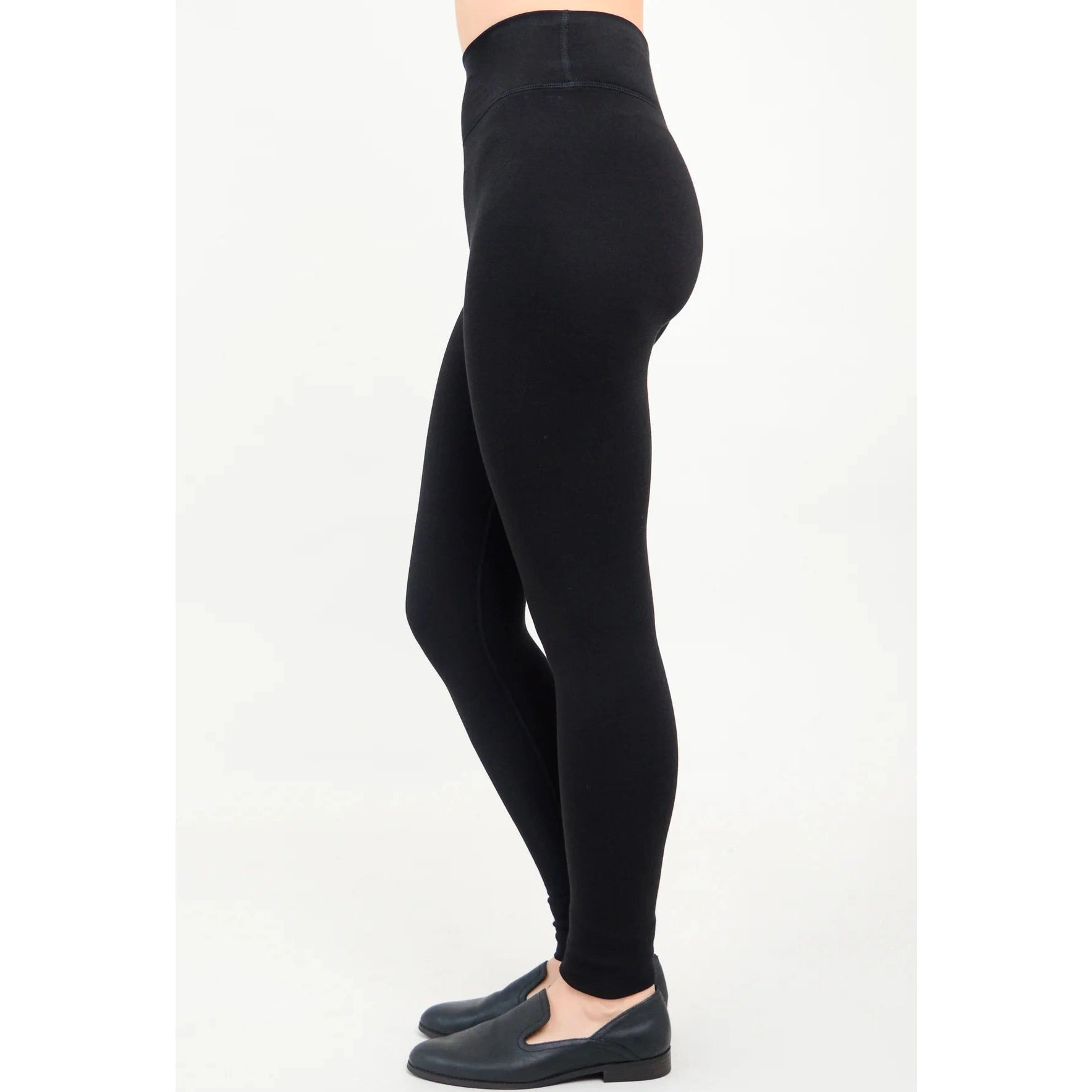 Blue Sky Riley Leggings in Black shown on a model against a white background, from the side view.