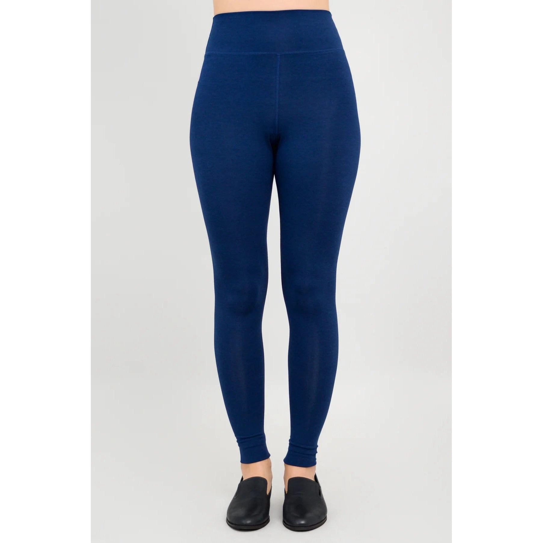 Blue Sky Riley Leggings in Indigo shown on a model against a white background, from the front view.