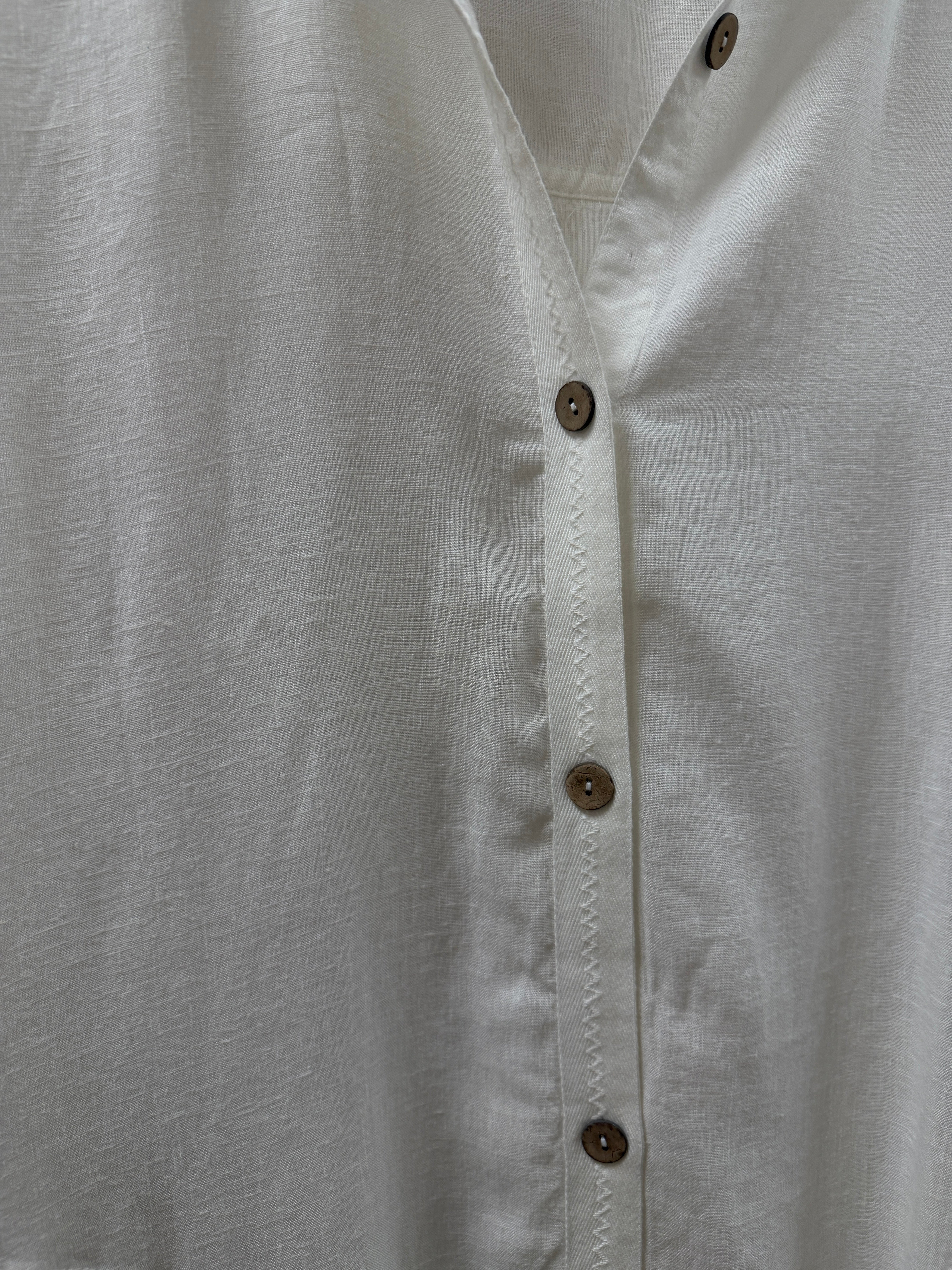 Close-up of a light white fabric with button details