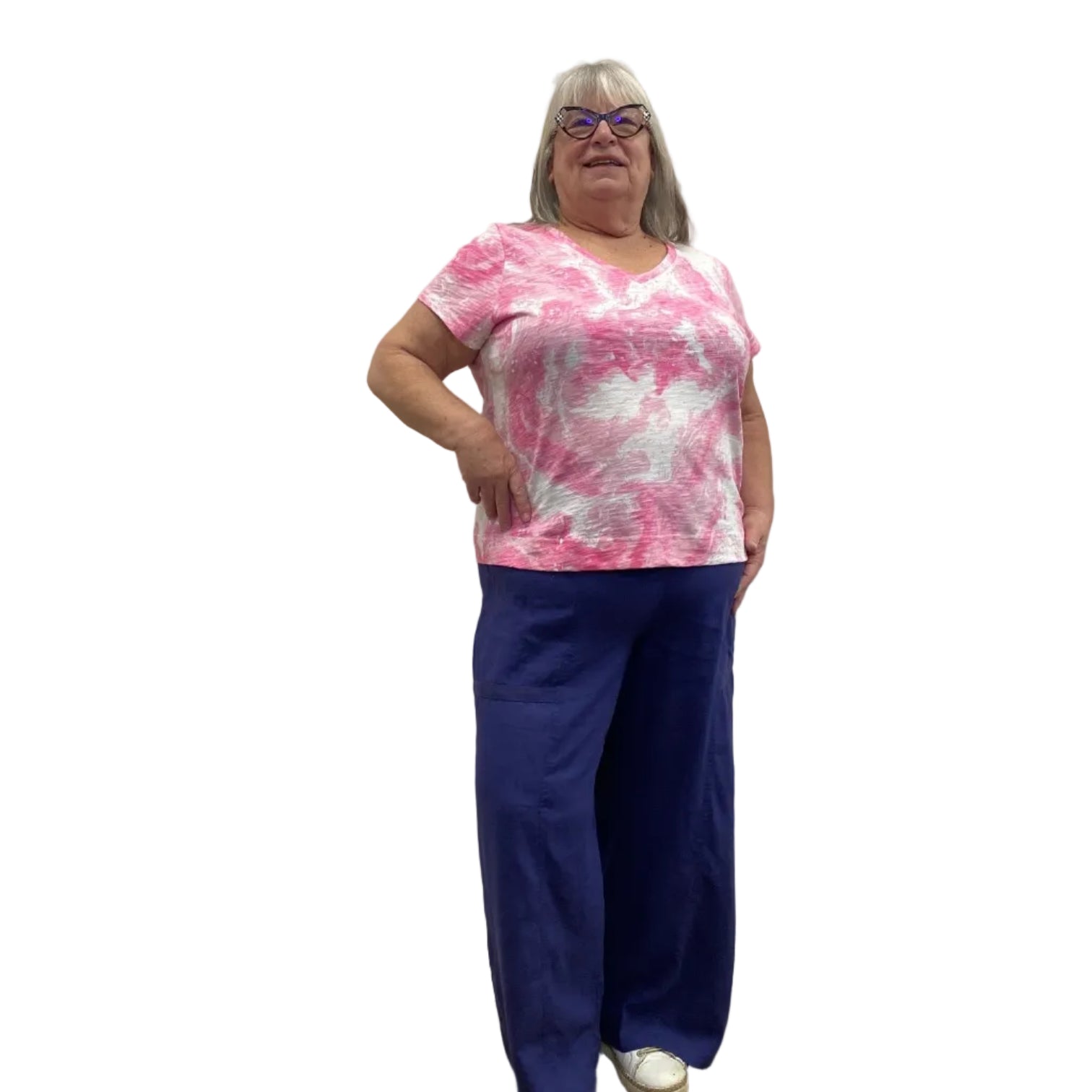 Woman wearing the Escape V Neck Tee in Cosmo pink and white paired with a navy pant against a white background.
