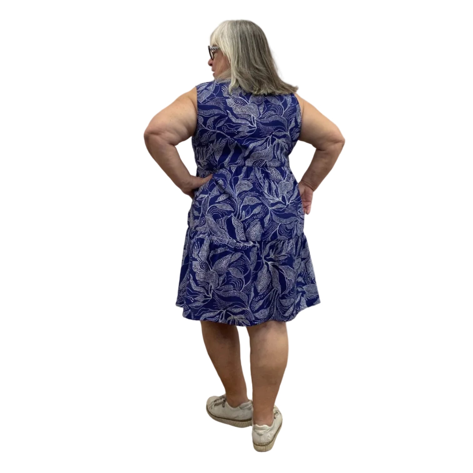 Woman wearing a Escape Paradise Dress in navy and white floral pattern against a white background.