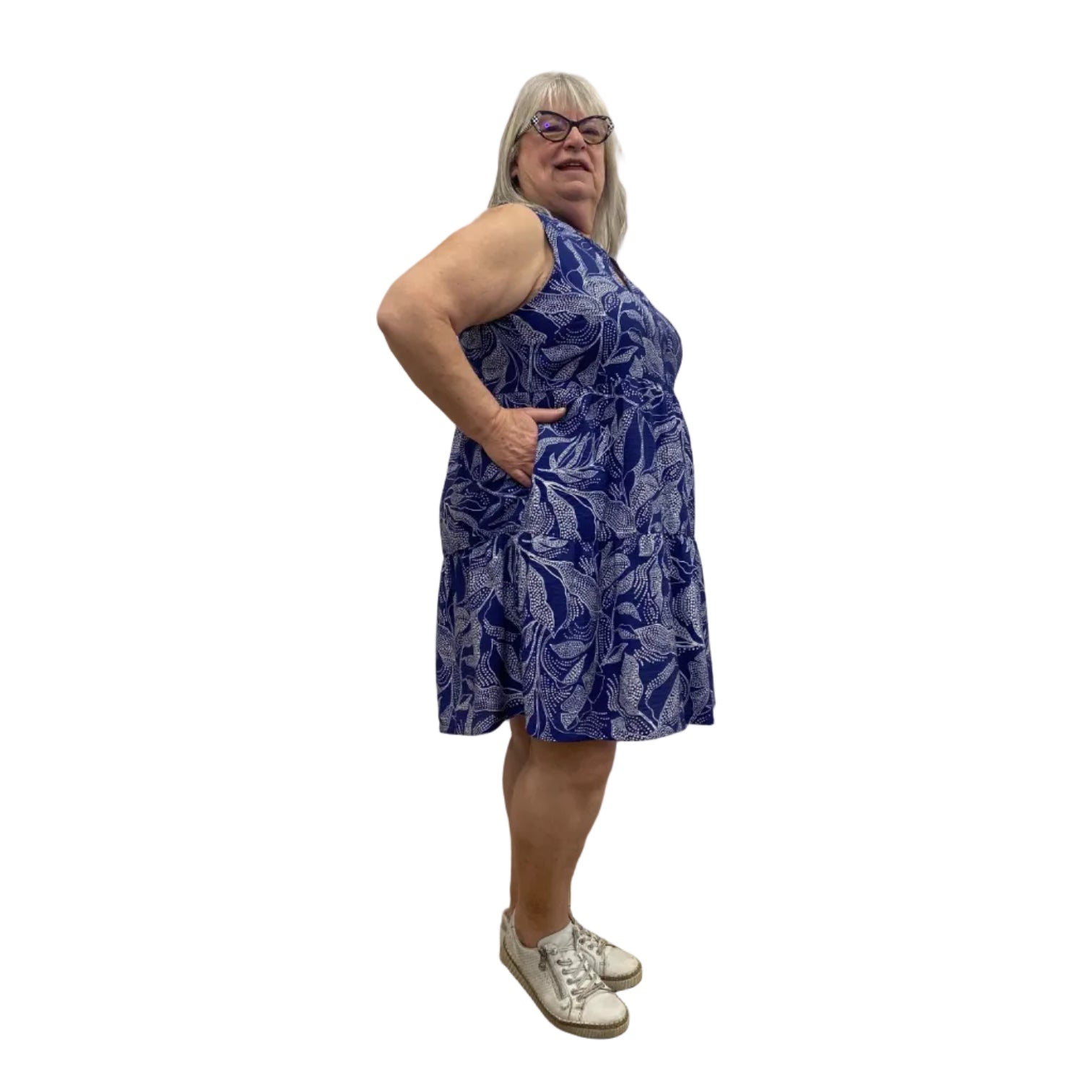 Woman wearing a Escape Paradise Dress in navy and white floral pattern against a white background.