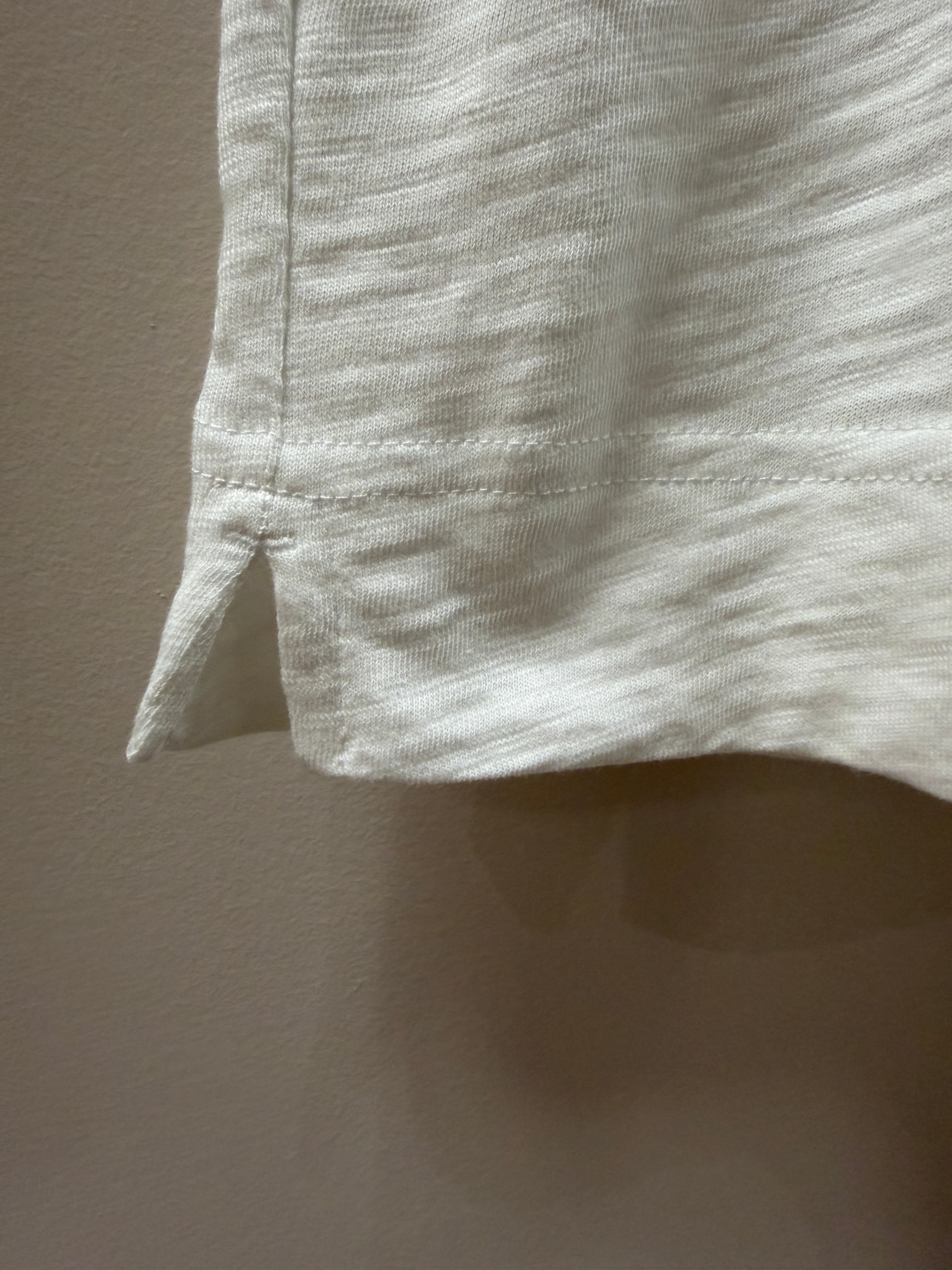 Close-up of a light white fabric with a subtle pattern on a matching background
