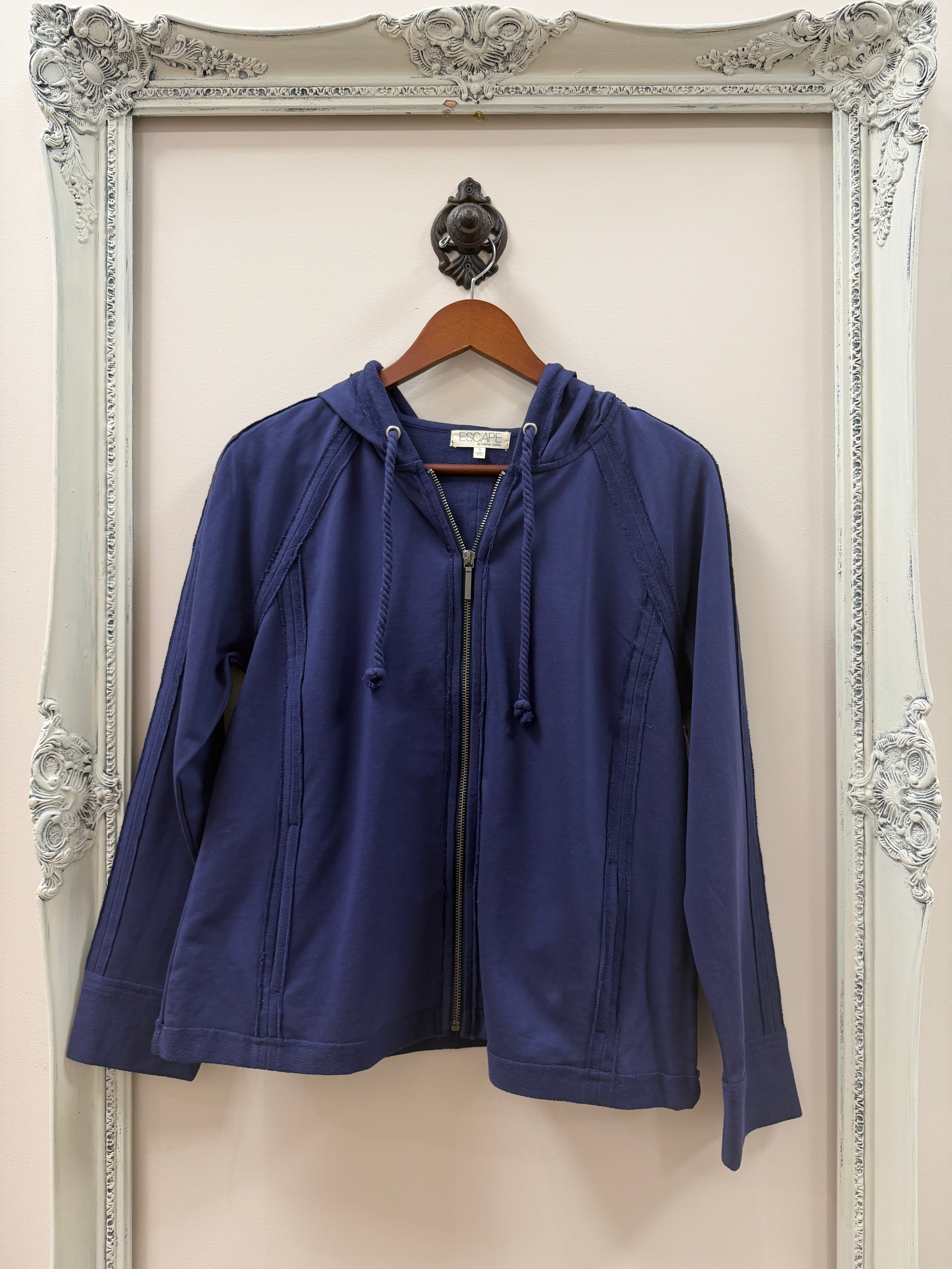 Blue jacket on a hanger against a decorative white background