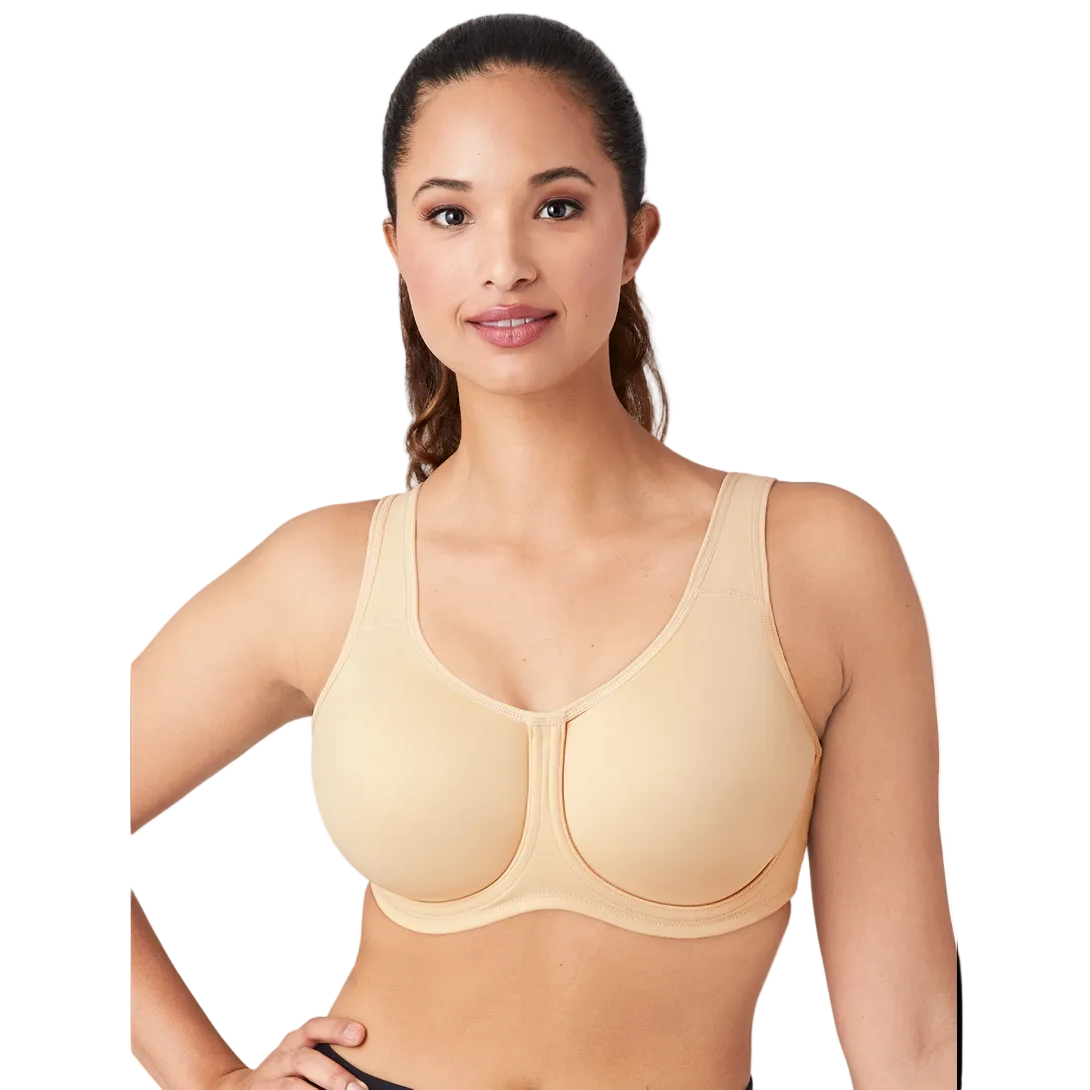 Woman wearing a sand-coloured Wacoal Simone Underwired sports bra on a white background