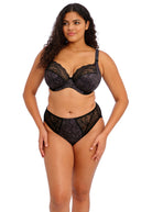 Woman wearing a black lace lingerie set on a white background