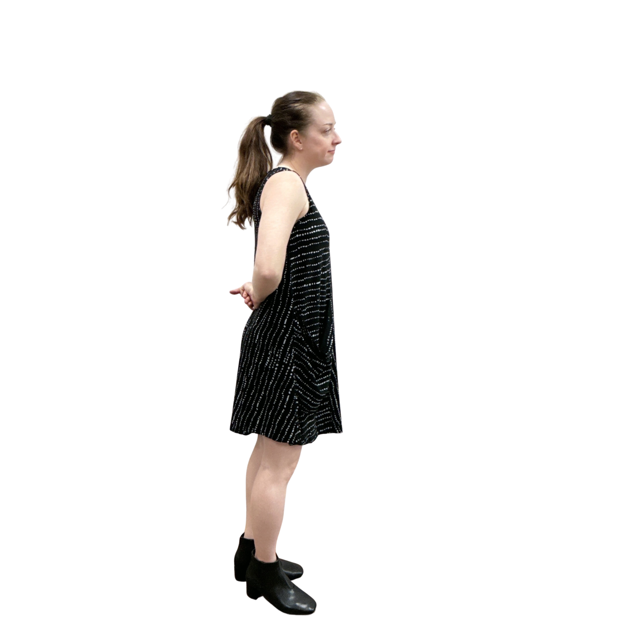 Woman wearing a black dress with white patterns on a white background