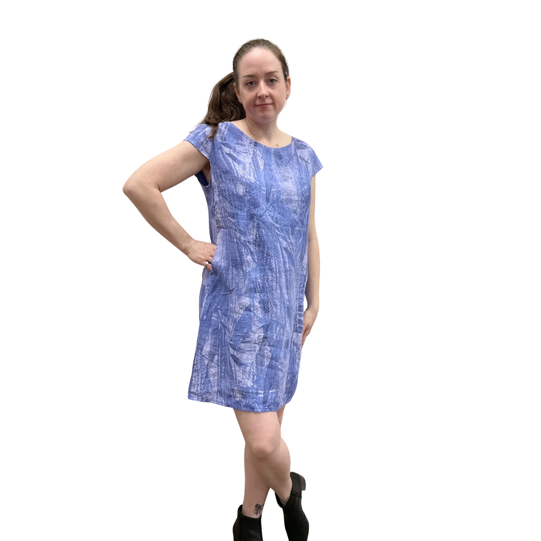 Woman wearing a blue patterned dress on a white background